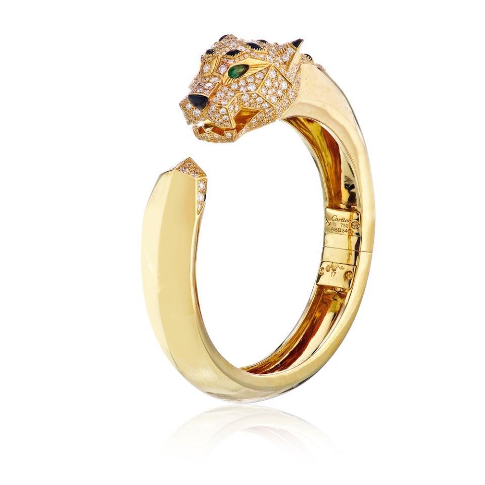 Cartier 18K Yellow Gold Diamond Black Onyx Panthère Cuff Size 17 Bracelet

The panther, which is a symbolic animal of Cartier, made its first appearance in the Maison's collections in 1914.
The panther can be fierce, playful, or lovable, displaying