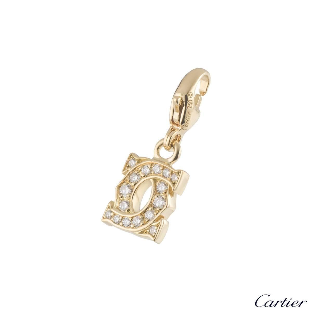 A mini 18k yellow gold diamond set Cartier charm from the C de Cartier collection. The charm comprises of the C de Cartier motif with 16 round brilliant cut diamonds in a pave setting, with a total weight of approximately 0.21ct, G colour and VS