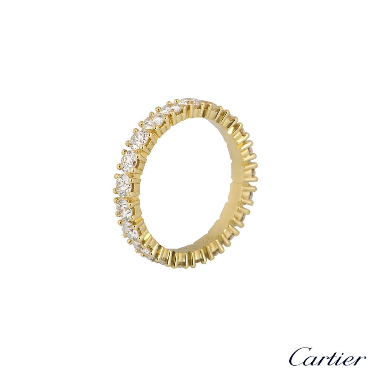 A beautiful 18k yellow gold Cartier diamond ring from the Etincelle De Cartier collection. The ring comprises of a full eternity of 21 round brilliant cut diamonds in a shared 4 claw setting all the way round. The diamonds have a total weight of