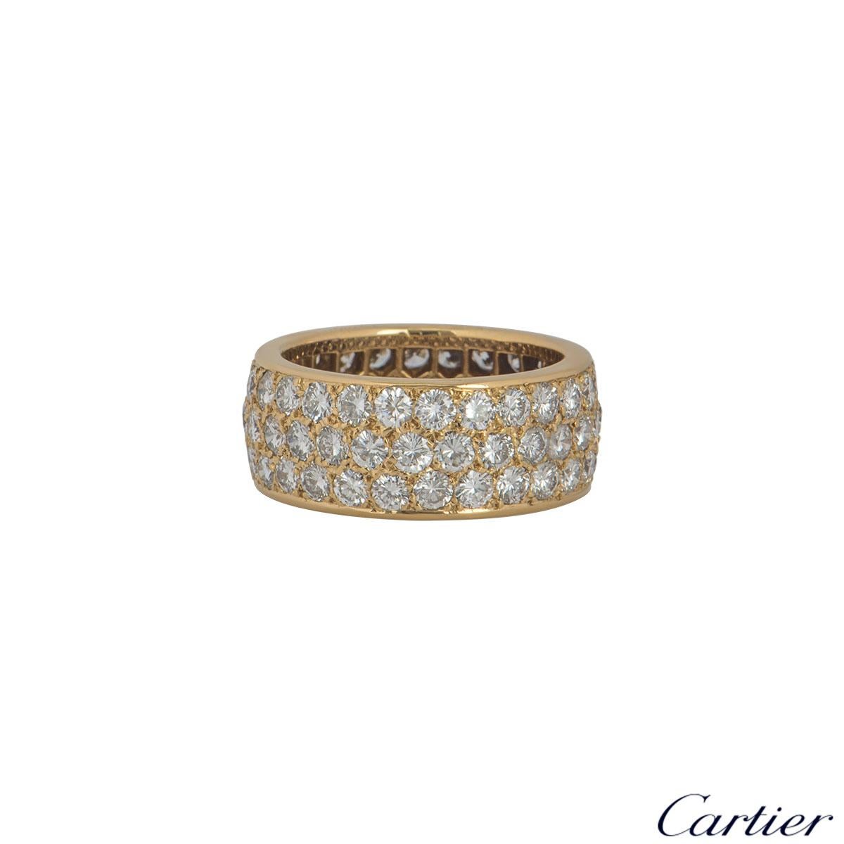 An elegant 18k yellow gold pave set diamond full eternity ring by Cartier. The ring comprises of 72 round brilliant cut diamonds in a unique three row pave setting, with a total weight of approximately 3.60ct, G colour and VS in clarity. The ring