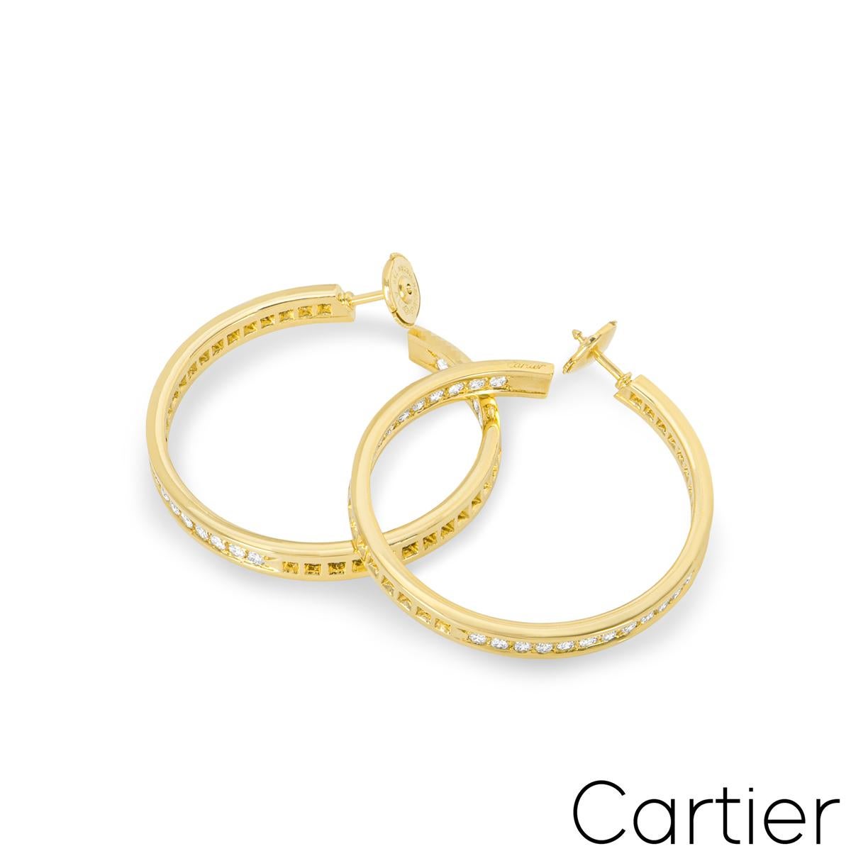 A stunning pair of Cartier 18k yellow gold diamond hoop earrings. The earrings are pave set to the front and inner side of the hoop with 84 round brilliant cut diamonds for a total approximate weight of 1.93ct, F-G colour and VS clarity. The