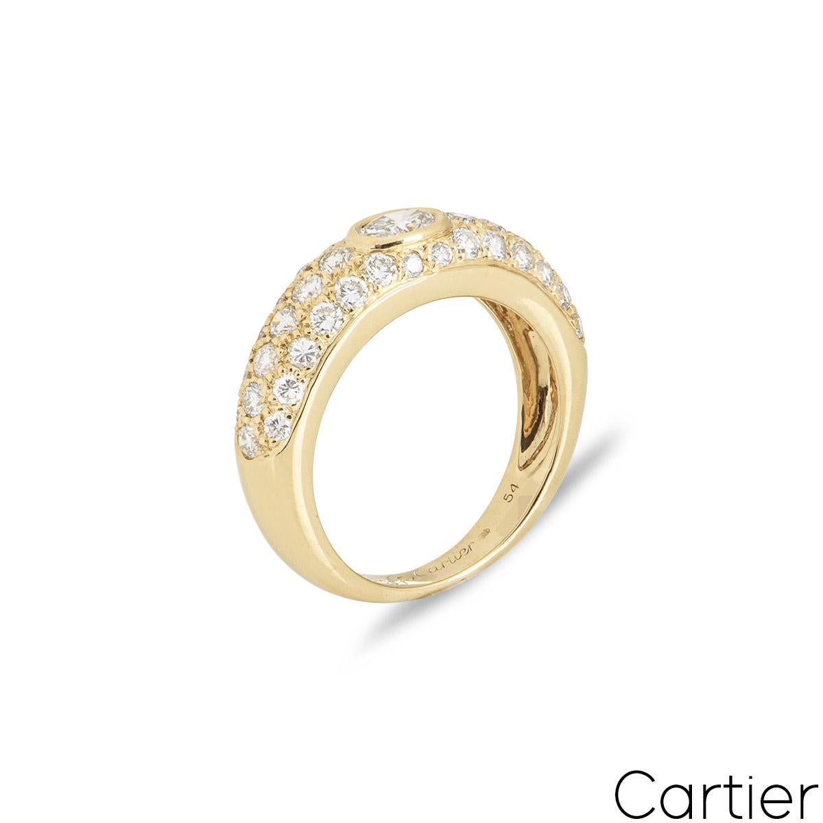 A timeless 18k yellow gold diamond ring by Cartier from the Mimi collection. The bombe style ring is set to the centre with an oval cut diamond in a bezel mount, weighing approximately 0.50ct, G colour and VS1 clarity. The central diamond is