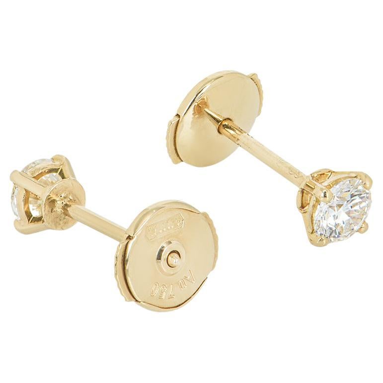 A pair of 18k yellow gold Cartier diamond earrings from the 1895 collection. The earrings feature round brilliant cut diamonds in a classic four claw setting. The diamonds each weigh 0.23ct, are G colour and VVS1 clarity with one scoring an