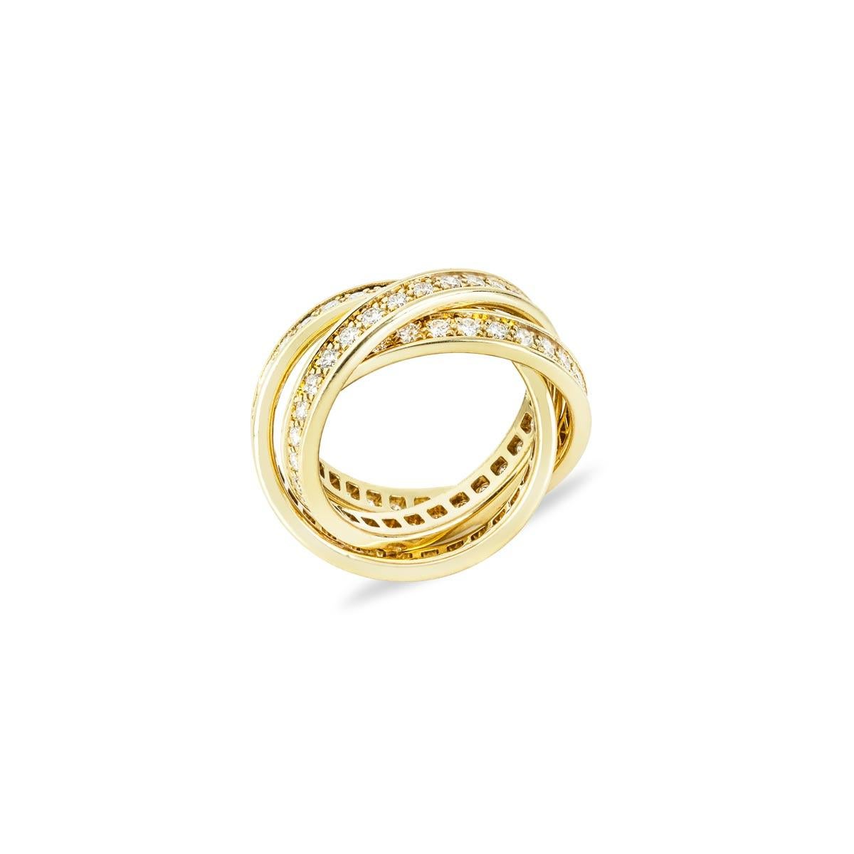 An iconic 18k yellow gold diamond set Cartier ring from the Trinity de Cartier collection. The ring is composed of three entwined round brilliant cut diamond set bands each 3mm in width, totalling approximately 1.55ct, G+ colour and VS+ clarity. The