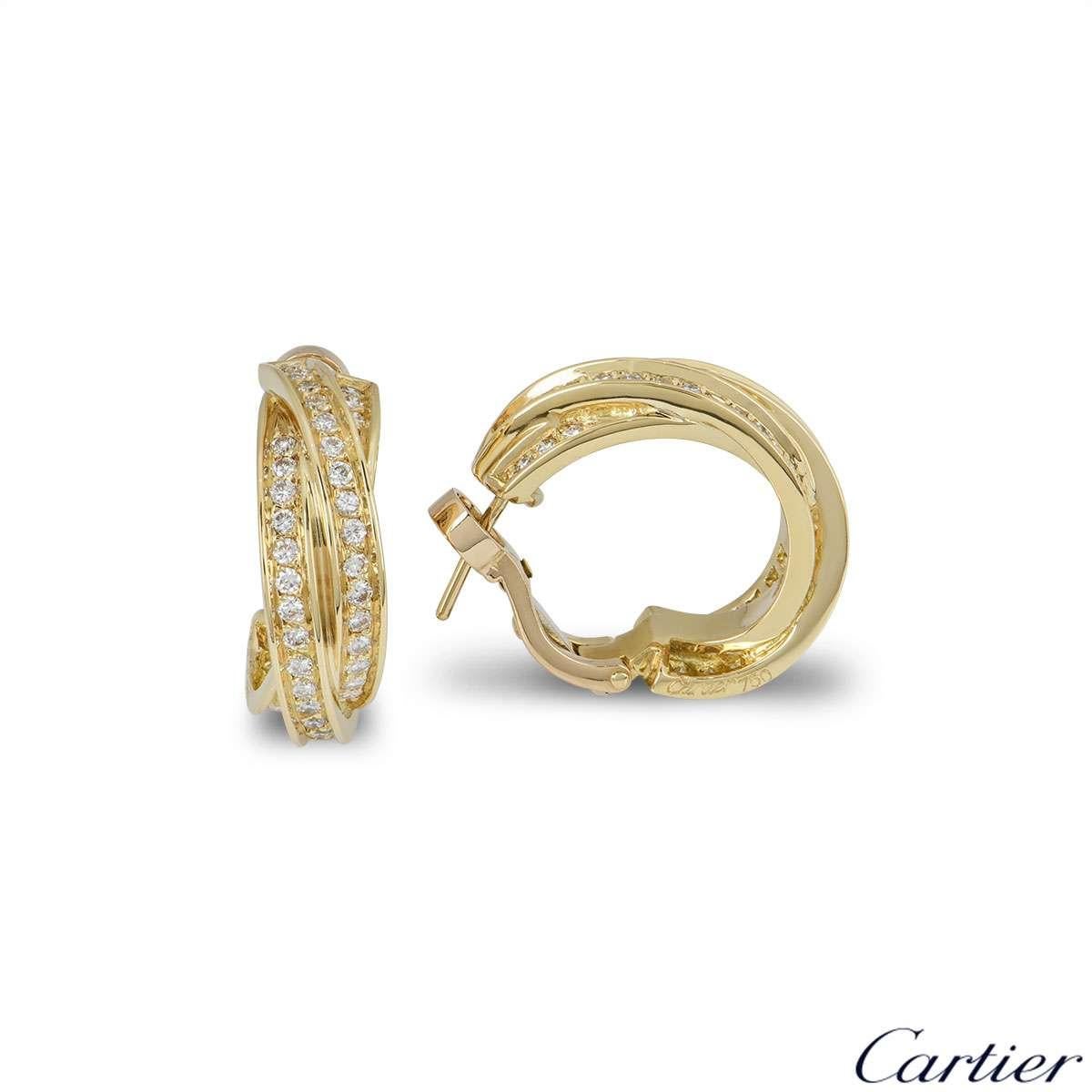 A sparkly pair of 18k yellow gold Cartier diamond hoop earrings from the Trinity de Cartier collection. The earrings comprise of 3 intertwined yellow gold bands with round brilliant cut diamonds pave set throughout. The earrings measure 22mm in