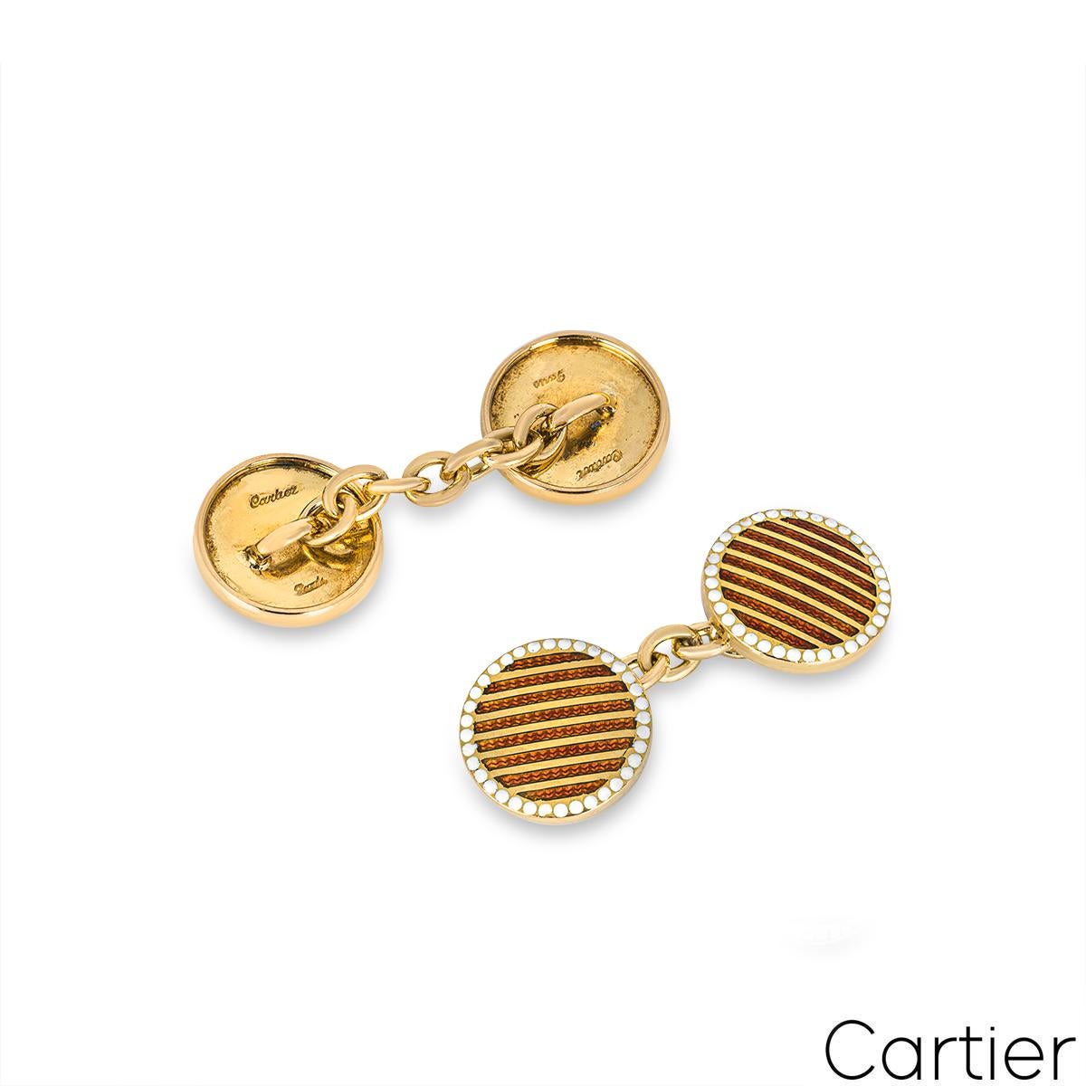 A rare yellow gold enamel dress set by Cartier. The set features a pair of cufflinks and 4 dress studs featuring a red enamel stripe pattern with a white enamel dot border. They measure 12mm in width and have a gross weight of 14.23 grams.

Comes