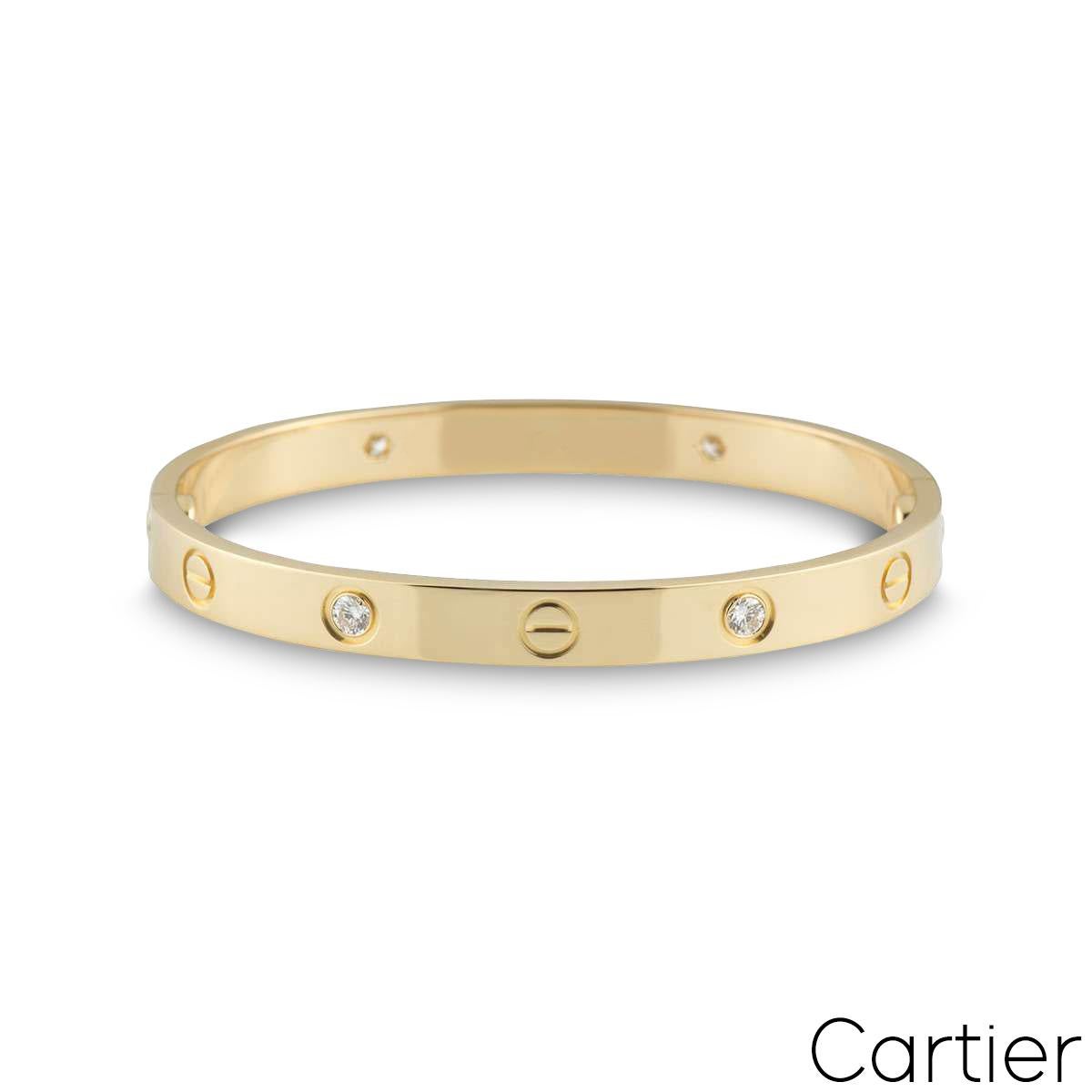 An iconic 18k yellow gold, Cartier half diamond bracelet from the Love collection. The bracelet comprises of the screw motif design alternating with four round brilliant cut diamonds in a rubover setting with a weight of 0.42ct. A size 19 and