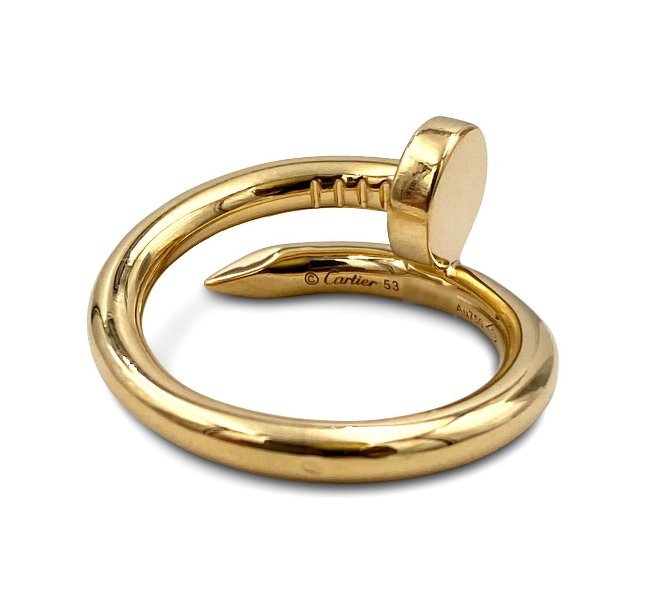Designed as a 'just a nail', this authentic Cartier 'Juste un Clou' ring is modern, transcending the every day, yet bold. The nail ring is an innovative twist on a familiar and ordinary object. Signed Cartier, 53, Au750. Ring is 2.65m in width and a