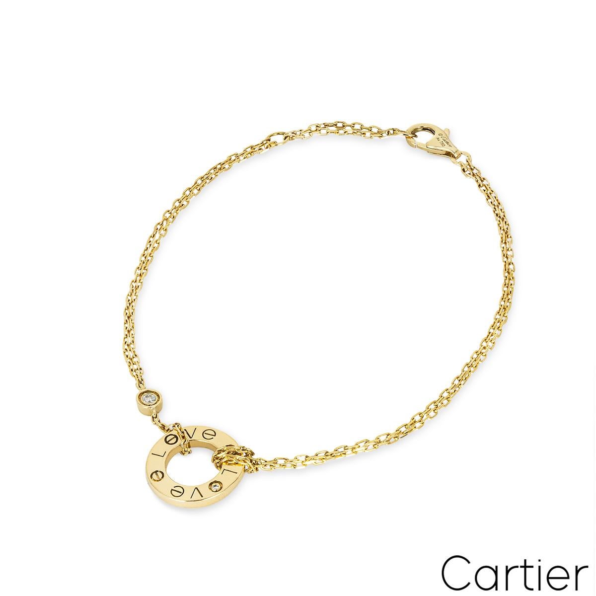 An 18k yellow gold bracelet by Cartier from the Love collection. The bracelet features a double yellow gold bracelet knotted to an open circular motif engraved with 'LOVE', the 'O' is set with a single round brilliant cut diamond. The bracelet is
