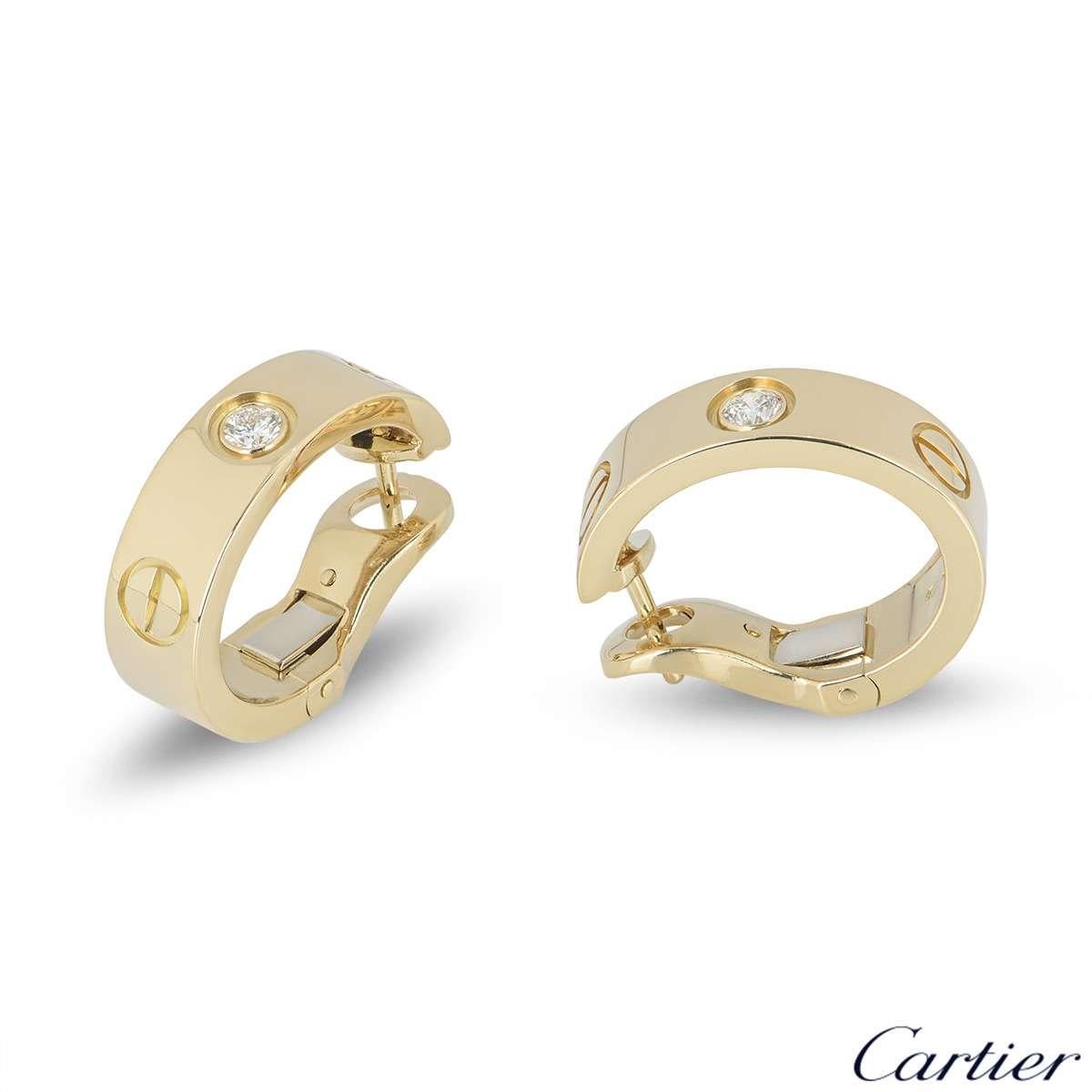 A pair of 18k yellow gold diamond earrings from the iconic Love collection by Cartier. Each hoop earring is set with a single round brilliant cut diamonds. The earrings are 18mm in length and 5mm in width and feature a post and lever hinged