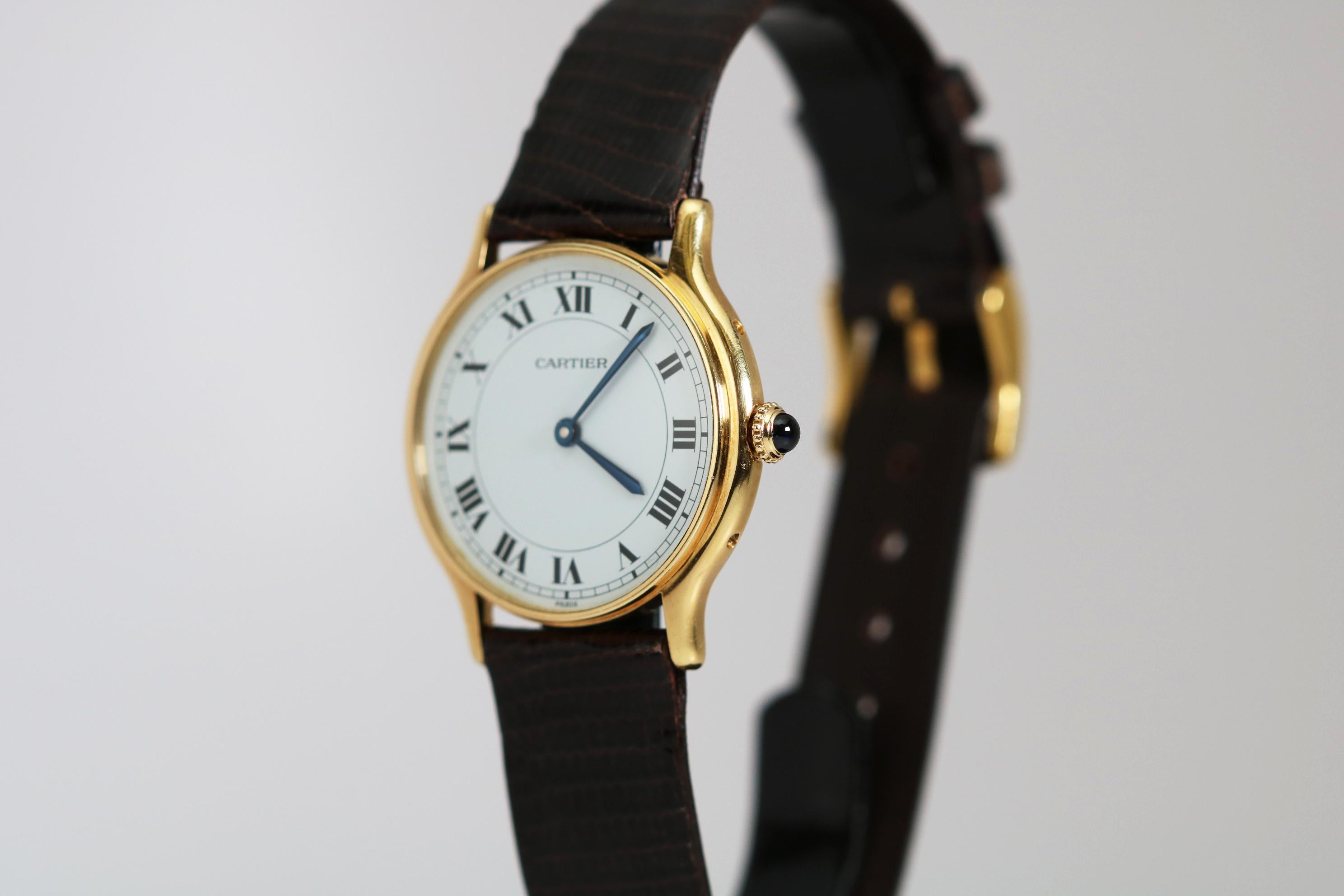 Brand: Cartier Paris
Model/Ref: Dress
Movement: Cartier Manual Wind 17-Jewels
Case: 18k Yellow Gold
Dial: White with Roman Numerals Stamped Paris
Dimensions: 30mm
Band: Brown Lizard made in Italy
Lug Width: 16mm
Year: 1980s
Box/Papers: No