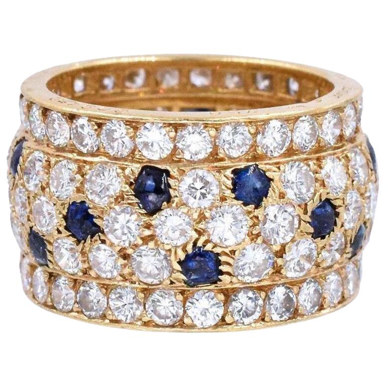 Diamond and sapphire 'Nigeria' ring, Cartier, France.
The band ring set with round diamonds weighing approximately 5.60 carats, with buff-top sapphire accents,
Ring size is 6.5 to 6.75.
Signed Cartier, with French assay and maker's marks.
With the