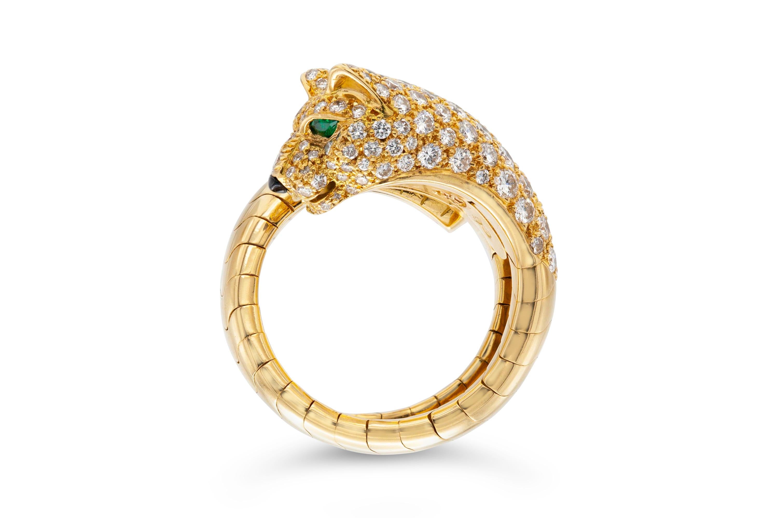 Finely crafted in 18K yellow gold featuring round-brilliant cut diamonds half way around weighing 2.07 carats, as well as two emerald eyes and a black onyx nose. 
Size 50, flexible. Not resizable. 
Singed and numbered by Cartier, from their Panthere