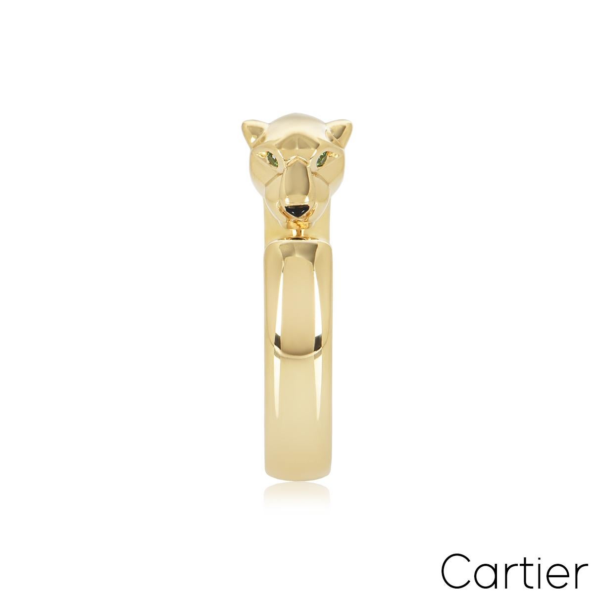 Magnifique bague en or jaune 18 carats de Cartier, de la collection Panthère de Cartier. La bague comprend un motif de tête de panthère serti de deux tsavorites rondes en guise d'yeux et d'un nez en onyx. La bague est de taille UK P½, EU 57/ US 7.75