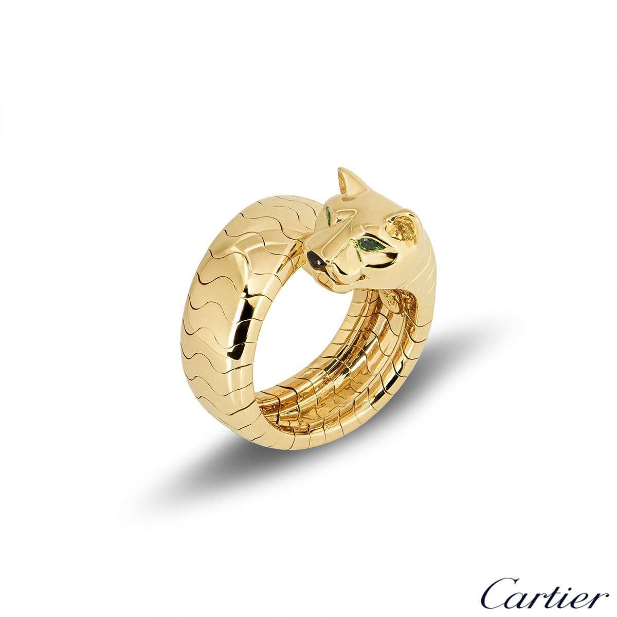 An 18k yellow gold ring from the Panthere collection by Cartier. The ring comprises of a Panthere head motif, set with tsavorite eyes and onyx nose. The body of the Panthere wraps around to form the band of the ring, measuring approximately 8mm in