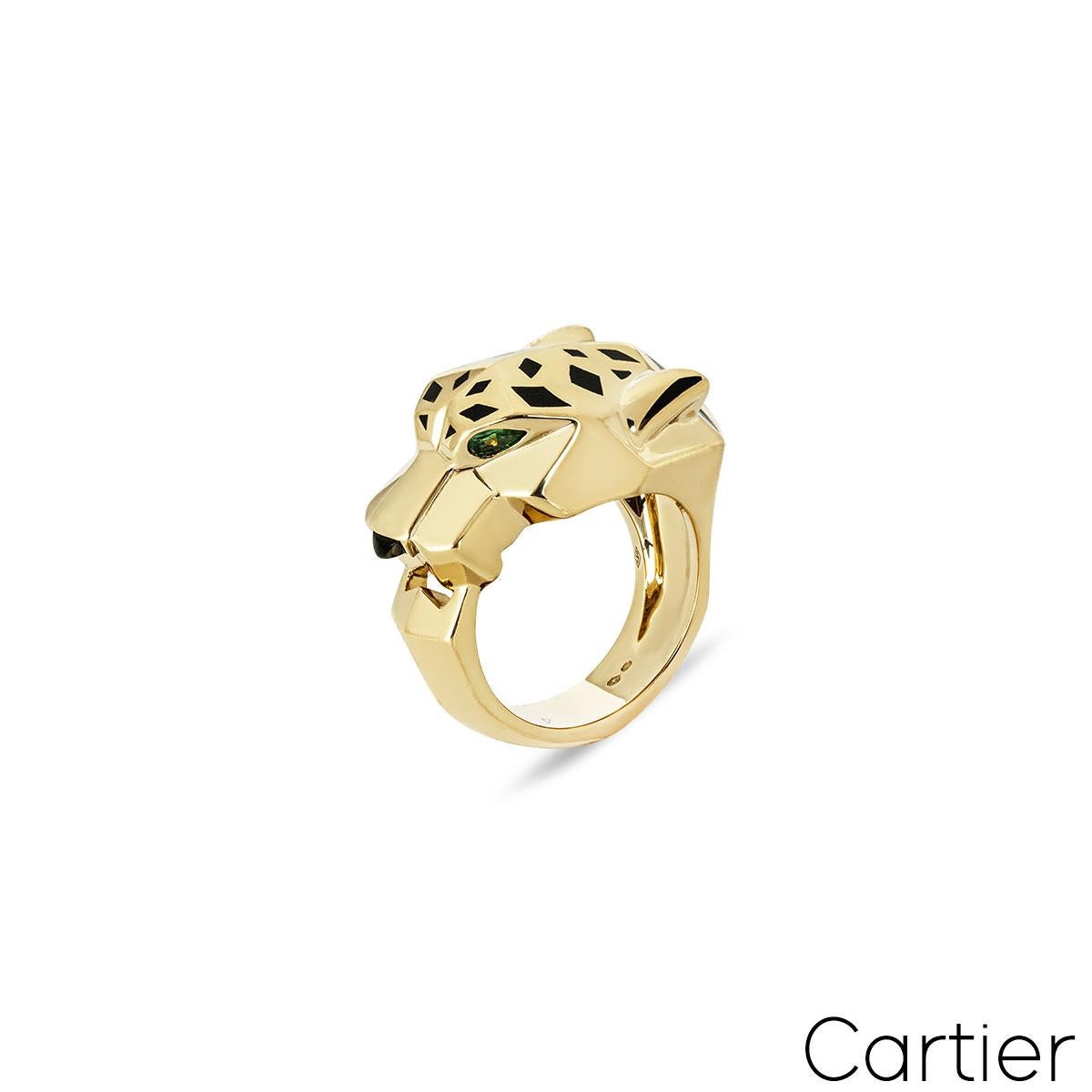 A beautiful 18k yellow gold ring by Cartier from the Panthere De Cartier collection. The ring is composed of a panthere head motif set with bold lacquer spots and is complemented with two tsavorite garnets set as the eyes with an onyx nose. The ring