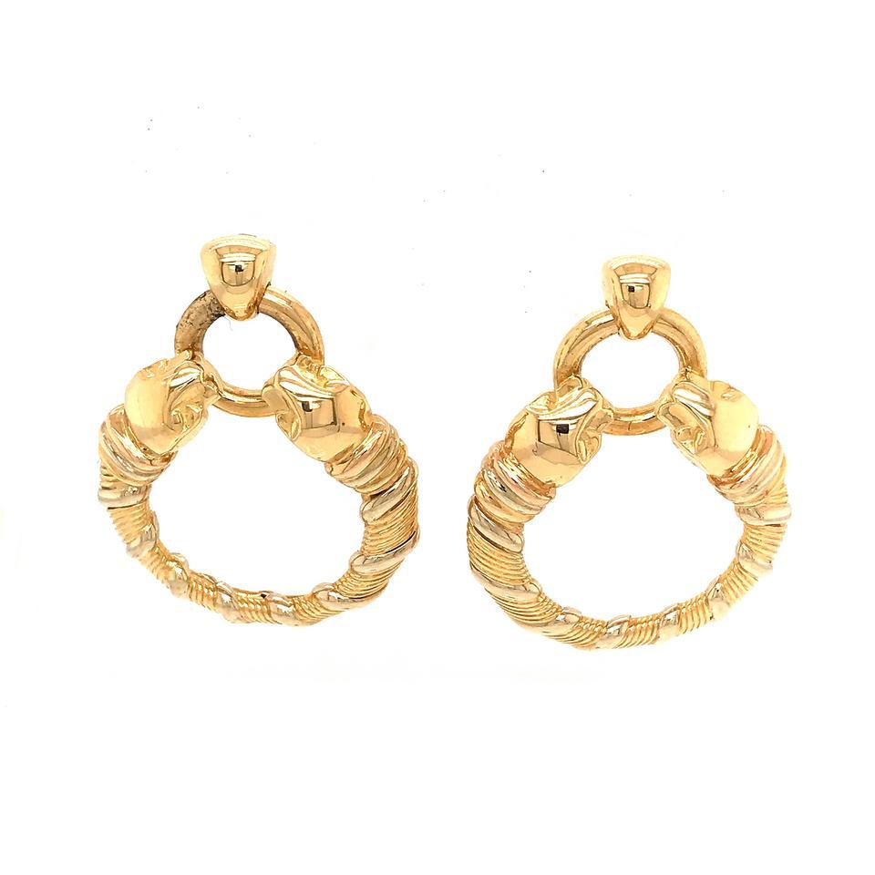 This pair of earrings from Cartier's Panthere collection have a clever design that is absolutely stunning. The earrings are made of yellow gold and boast dangling hoop accents. Upon further examination, one will find that each end of the hoops is a