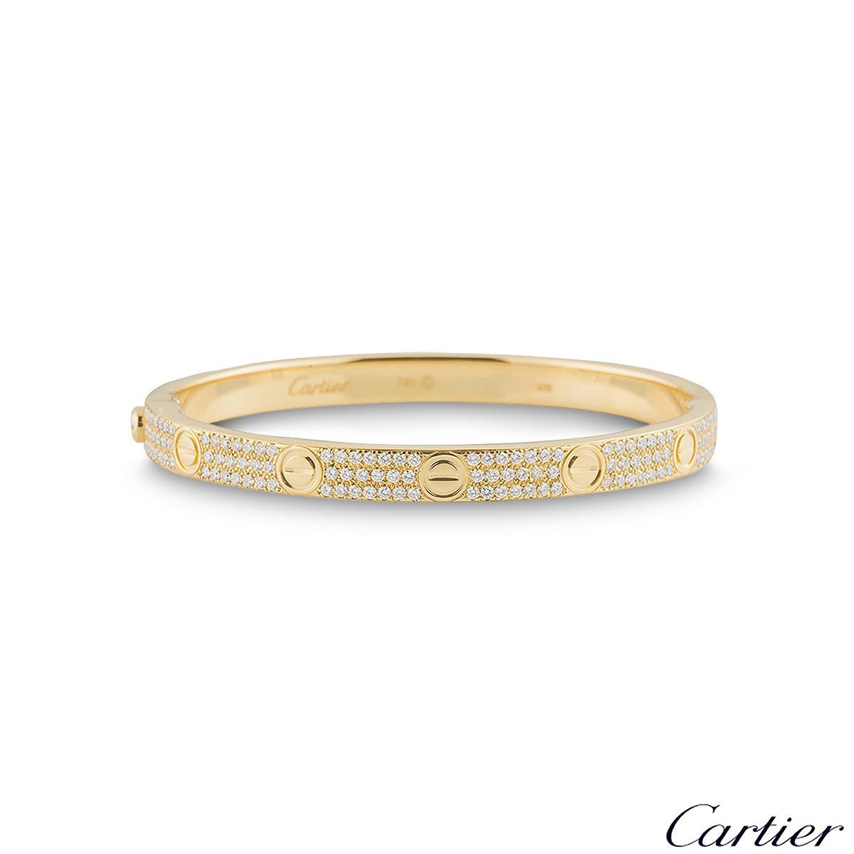 An iconic 18k yellow gold diamond bracelet by Cartier from the Love collection. The bracelet has the iconic screw motif displayed around the outer edge with 204 round brilliant cut diamonds pave set between each screw motif. The total diamond weight