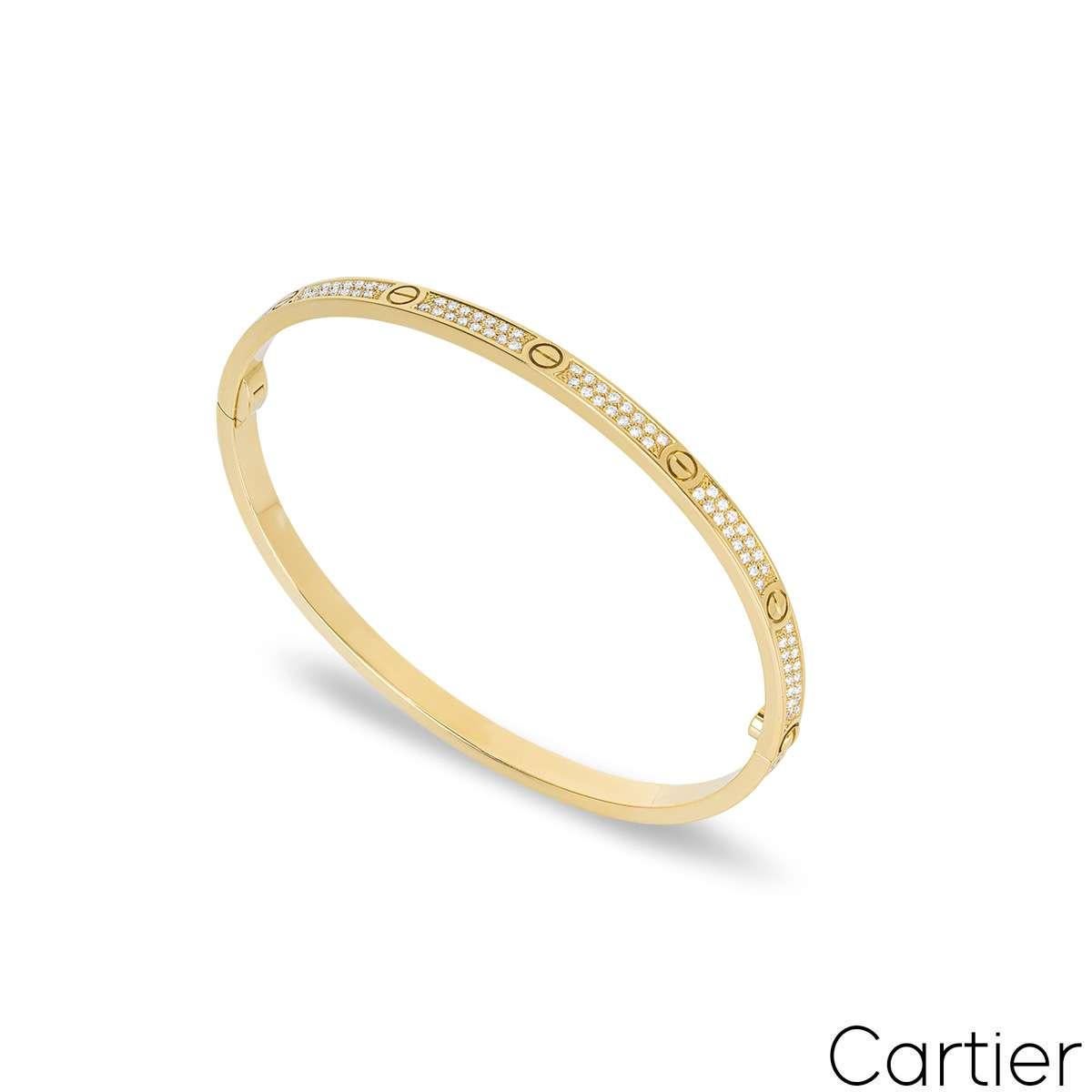 An 18k yellow gold diamond Cartier bracelet from the Love collection. The bracelet comprises of the iconic screw motifs around the outer edge, complemented with 177 round brilliant cut pave set diamonds. The diamonds have a total weight of 0.95ct,