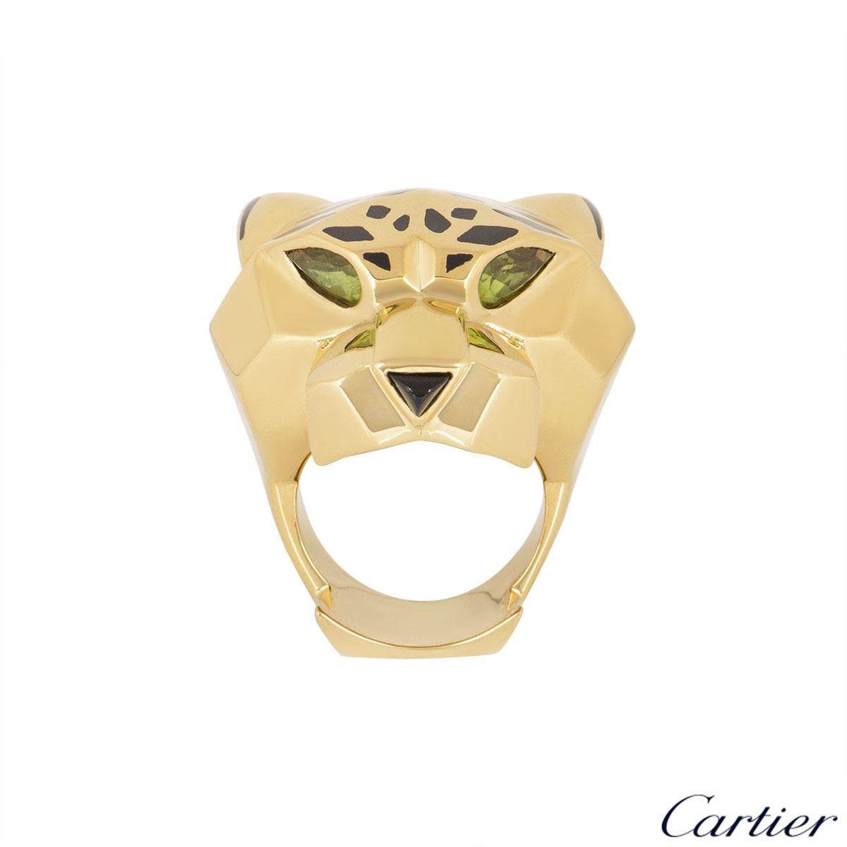 A beautiful 18k yellow gold ring by Cartier from the Panthere De Cartier collection. The ring is composed of a panthere head motif set with bold lacquer spots and is complemented with two peridots set as the eyes with an onyx nose. The ring is a