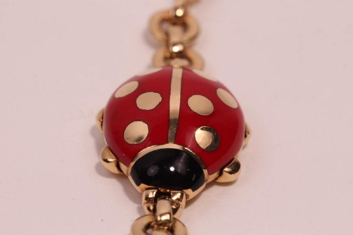 Vintage Cartier bracelet featuring an 18-karat yellow gold link chain, black and red enameled ladybug stations, and a lobster clasp. Released circa 1990. Total weight: 20 grams.

Ladybugs show signs of wear.

But it's consistent with age.