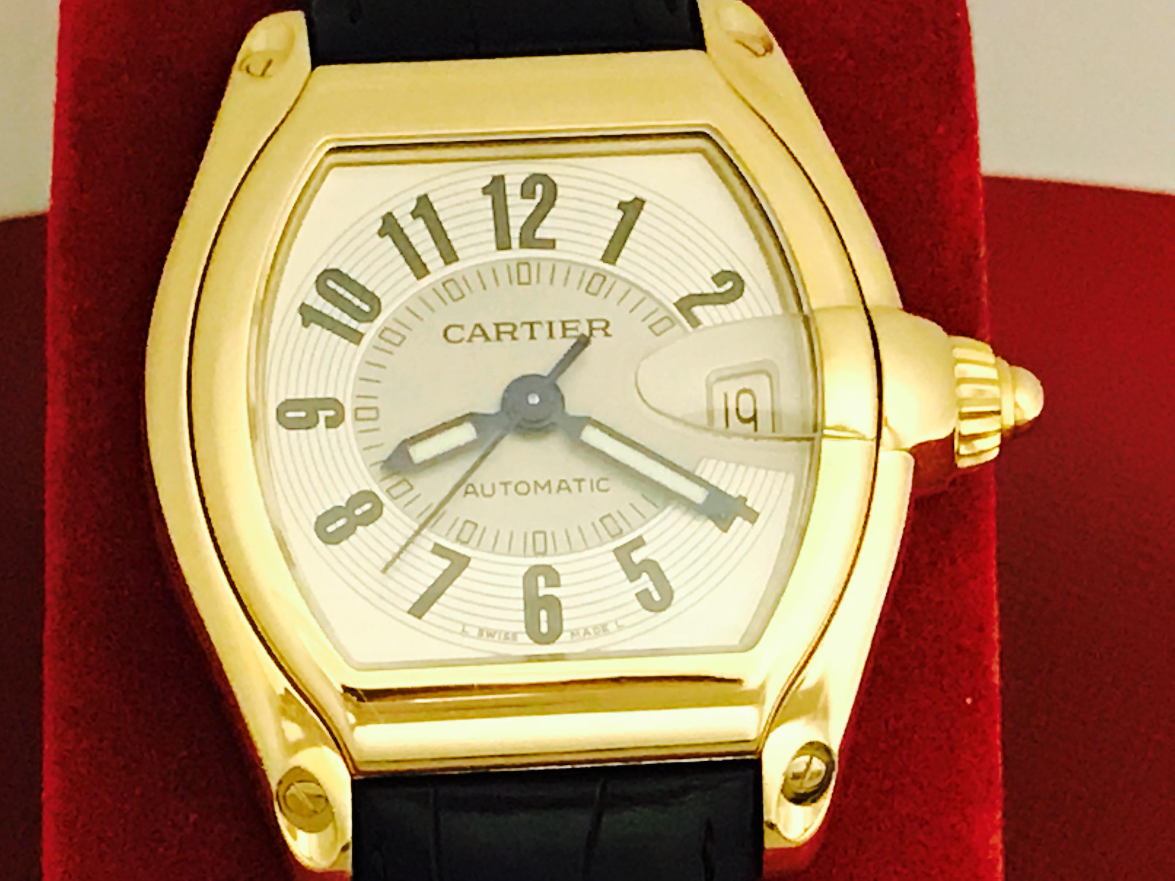 Mens Cartier Roadster Model W62002Y2. Automatic Winding movement with date. 18k yellow gold rectangular tonneau style case (37x44mm).  Black alligator strap with 18k Yellow Gold Cartier deployant clasp. Tu-tone silvered Dial with black Arabic
