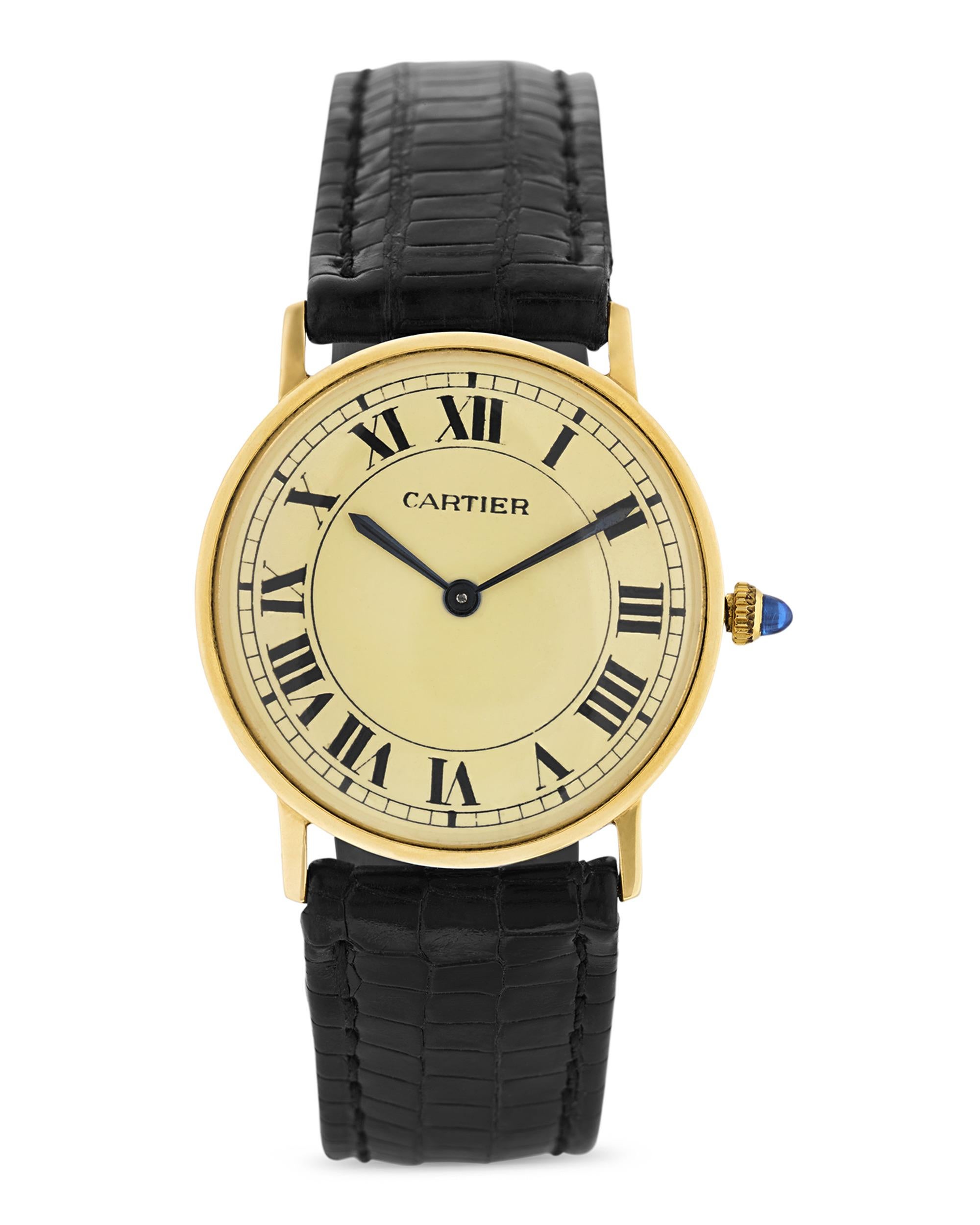 Elegance and timeless design define this classic Cartier Ronde wristwatch. Crafted in solid 18K yellow gold, the polished round case houses a white dial adorned with Roman numerals and Cartier’s signature blued steel sword hands. A cabochon sapphire