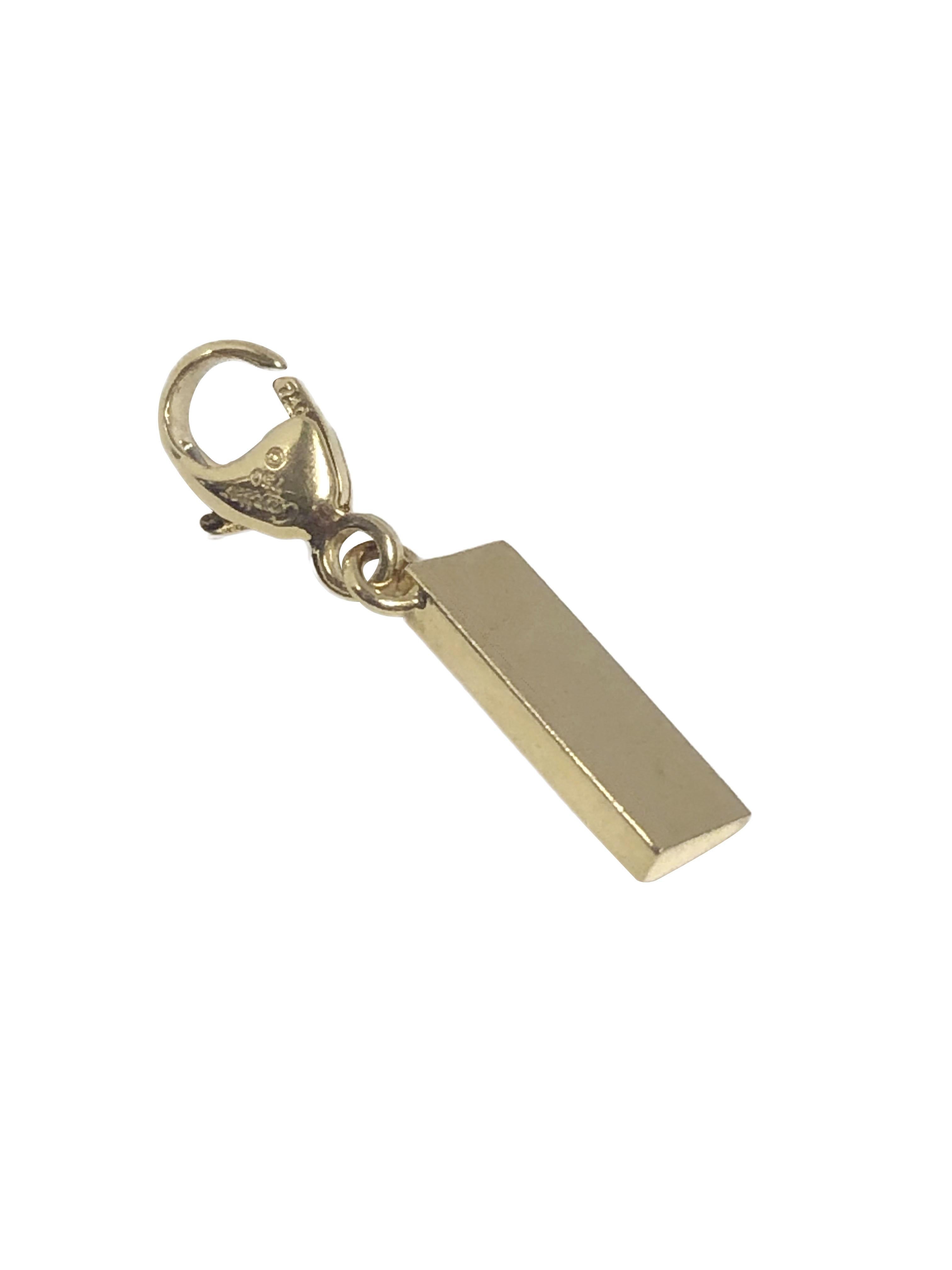 Circa 2000 Cartier 18k Yellow Gold Ruler Charm, measuring 3/4 inch in length including the lobster claw style lock. Signed and numbered. 