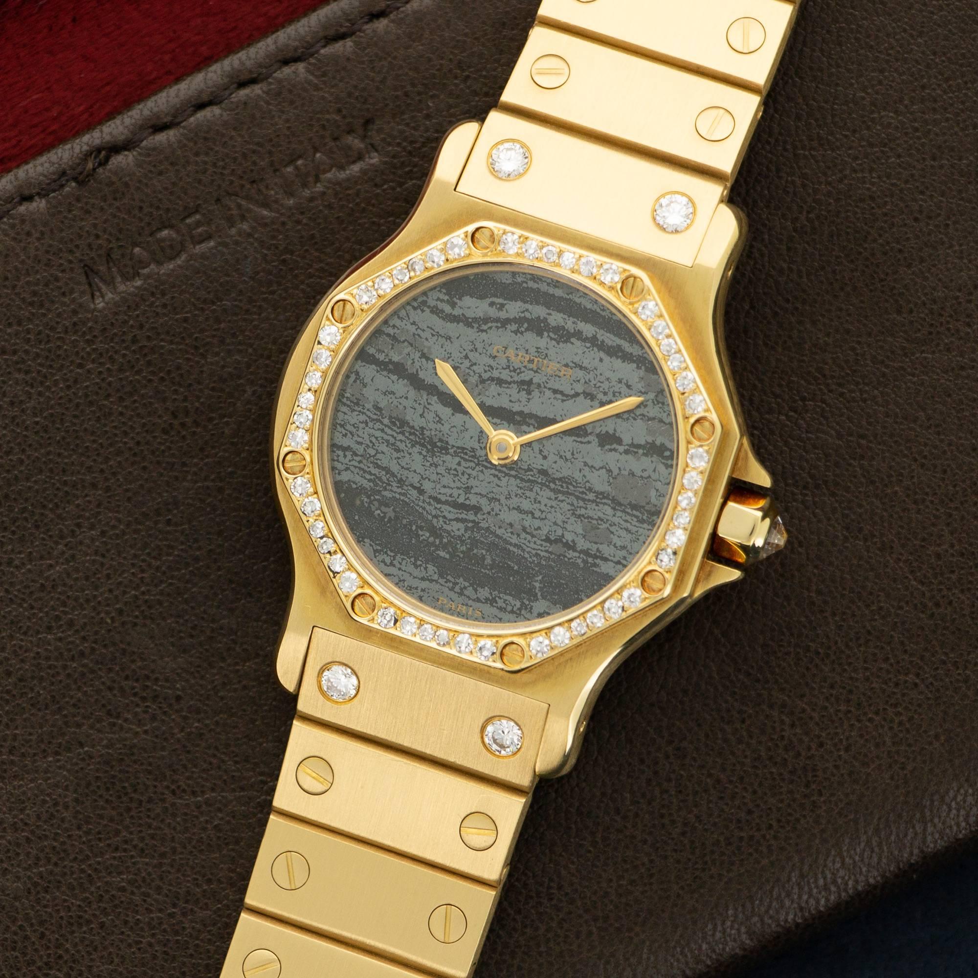 A Rare and Unique 18k Yellow Gold Santos Octagonal Watch by Cartier, Circa Mid 1980's. Original Diamond Bezel and End Links. Grey Aventurine Dial with Gold Hands. Automatic Movement. 32 mm Case Diameter. All Original .