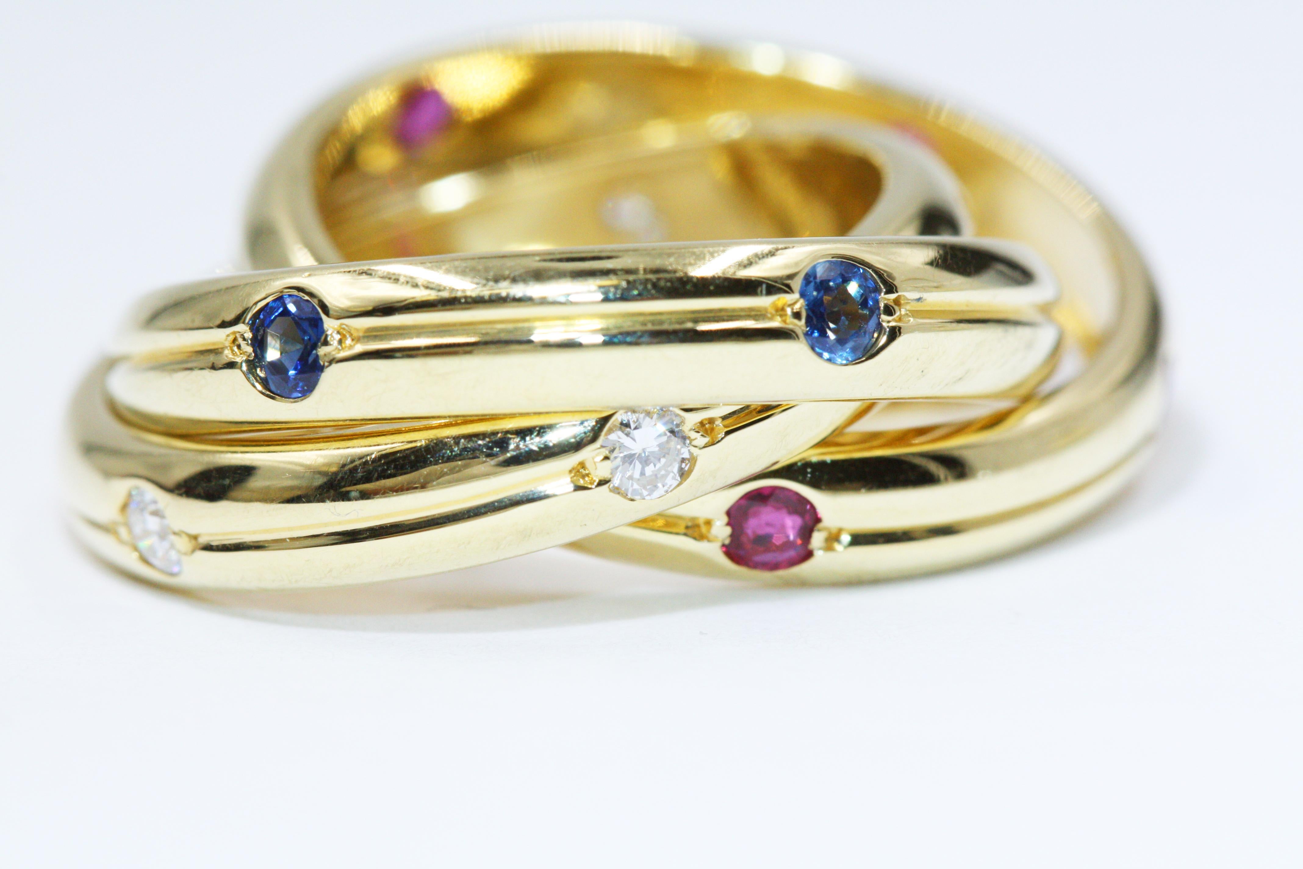 A unique Trinity ring from Cartier, made in yellow gold, set with sapphire diamonds.

Cartier Sapphire Diamond Ruby Ring 

Size EU54 US6.75
Weight: approximate 12.9g
This item will come with a pouch
Stock#: CTR315