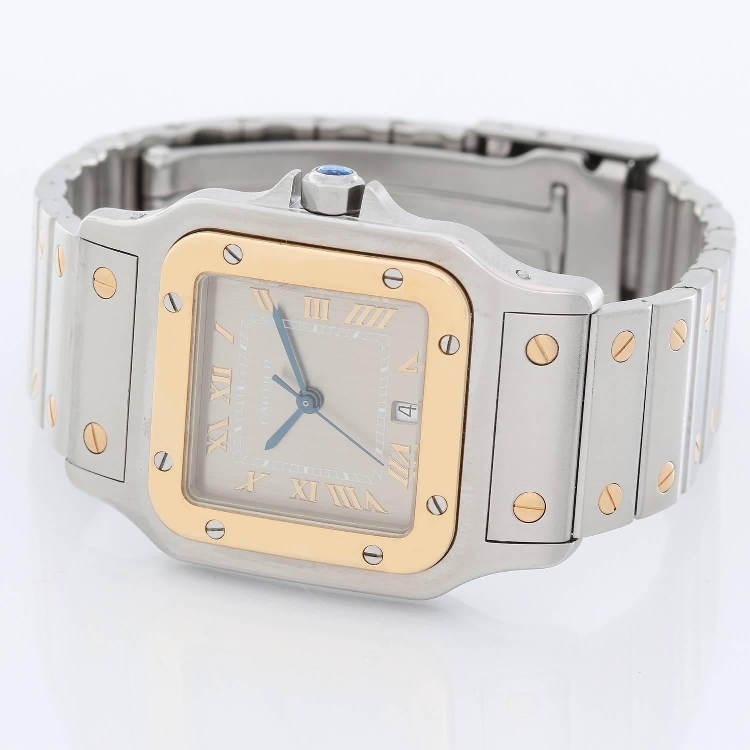 Cartier Santos Men's 2-Tone Steel & Gold Quartz Watch W20011C4 - Quartz. Stainless steel case with 18k yellow gold bezel (29mm x 41mm). Silver dial with gold Roman numerals and date at 6 o'clock. Stainless steel Santos bracelet with gold screws.