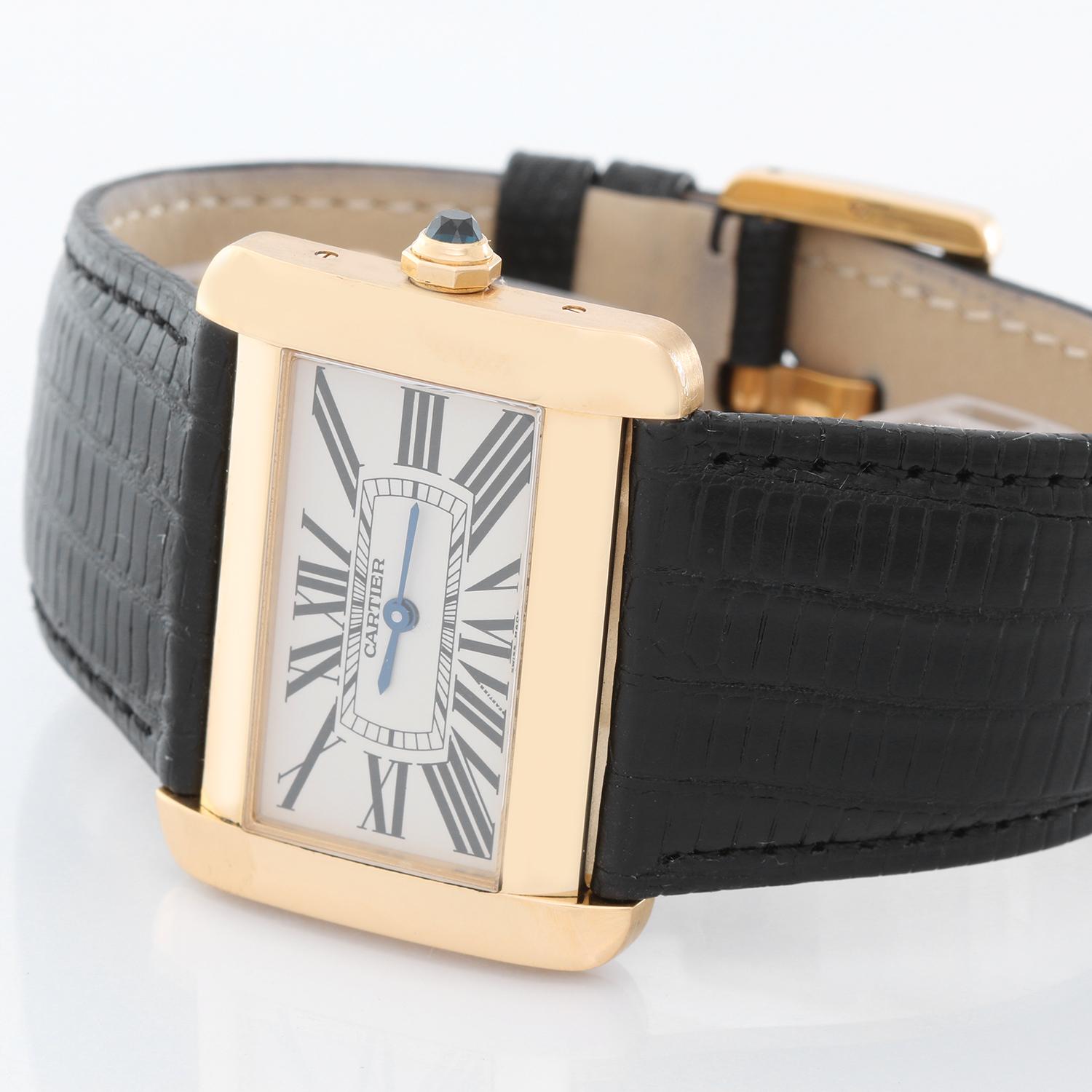 Cartier Tank Divan 18K Yellow Gold Watch W6300556 - Quartz movement. 18k yellow gold case (38mm x 30mm). Silvered guilloche dial with black Roman numerals. Cartier black leather strap. Pre-owned with custom box .