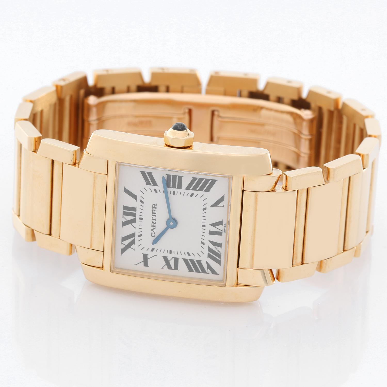 Cartier Tank Francaise Midsize 18k Yellow Gold Men's/Ladies Watch W50003N2 -  Quartz. 18k yellow gold  case; blue sapphire cabochon crown (25mm x 30mm). Ivory colored dial with black Roman numerals. Cartier 18k yellow gold bracelet. Pre-owned with