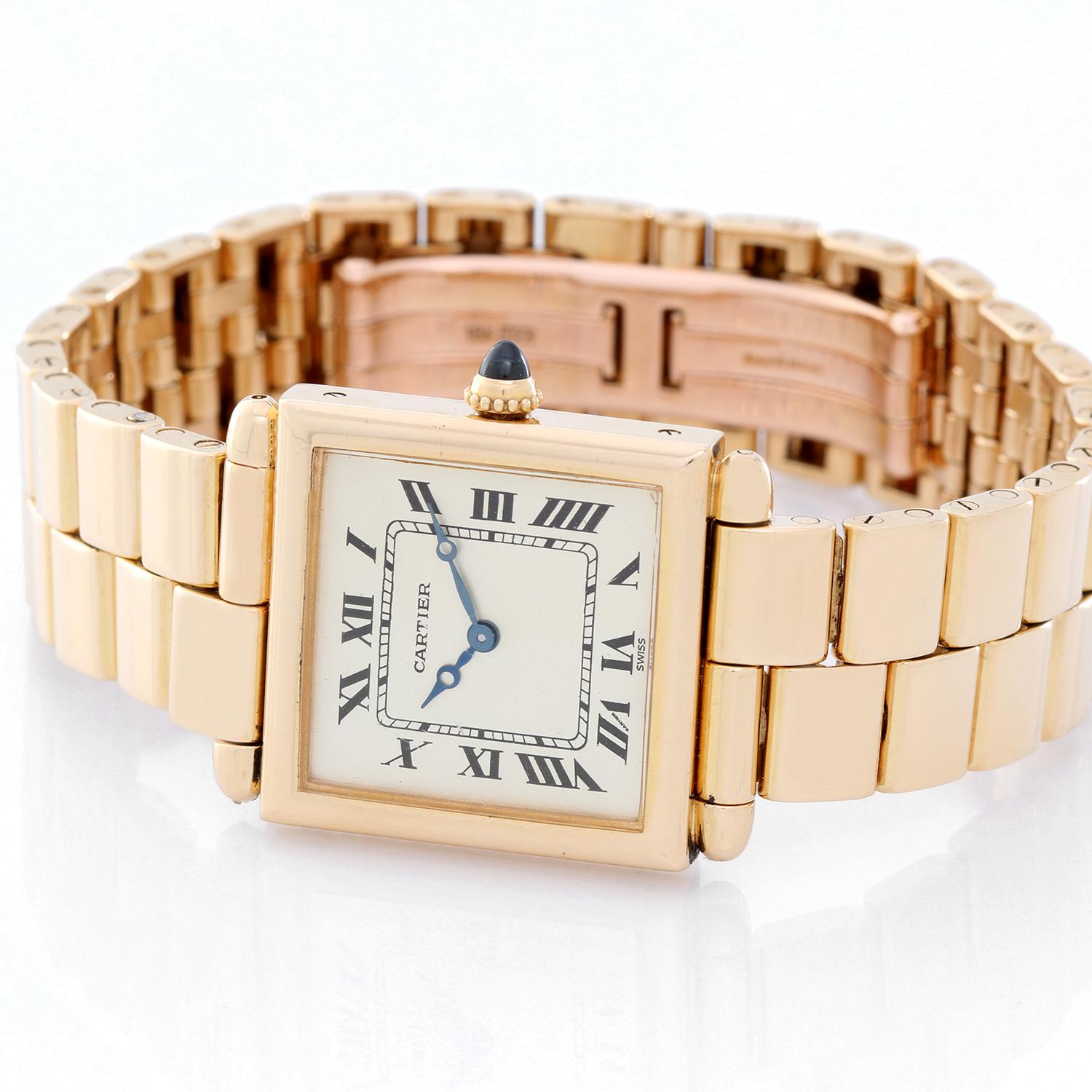 Cartier Tank Obus Men's or Ladies 18k Yellow Gold Watch - Quartz. 18k Yellow gold case (25mm x 32mm). Silvered dial with black Roman numerals. 18K Yellow gold bracelet with double deployant clasp. Pre-owned with custom box .