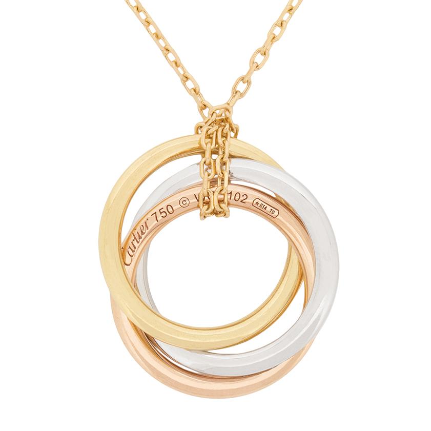 This stunning piece from Cartier is part of the Trinity collection. It feature three rings of gold, each in 18 carat, but one made in yellow gold, one made in pink gold and the final in white gold is also grain set within sparkling diamonds. The