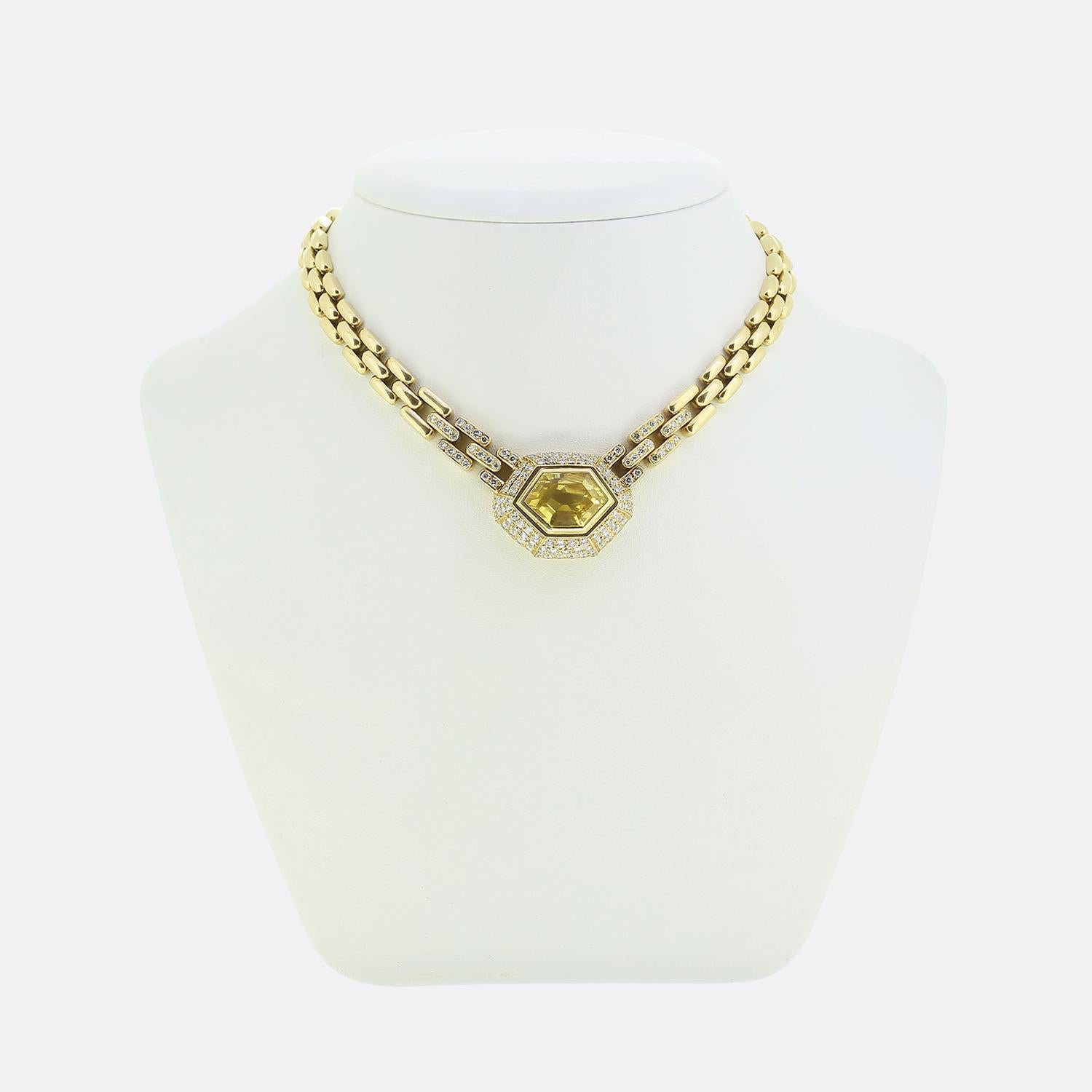Here we have a sensational necklace from the world renowned luxury jewellery house of Cartier. The centrepiece is a striking hexagonally shaped yellow sapphire, radiating a warm, golden hue. This captivating gem is surrounded by three rows of