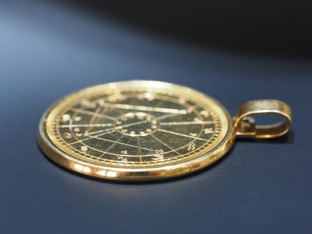 This incredible 18 Karat Gold Zodiac Medallion by Cartier is exquisite when worn on a gold chain. This rare medallion features a chart design with zodiac signs on the front. 