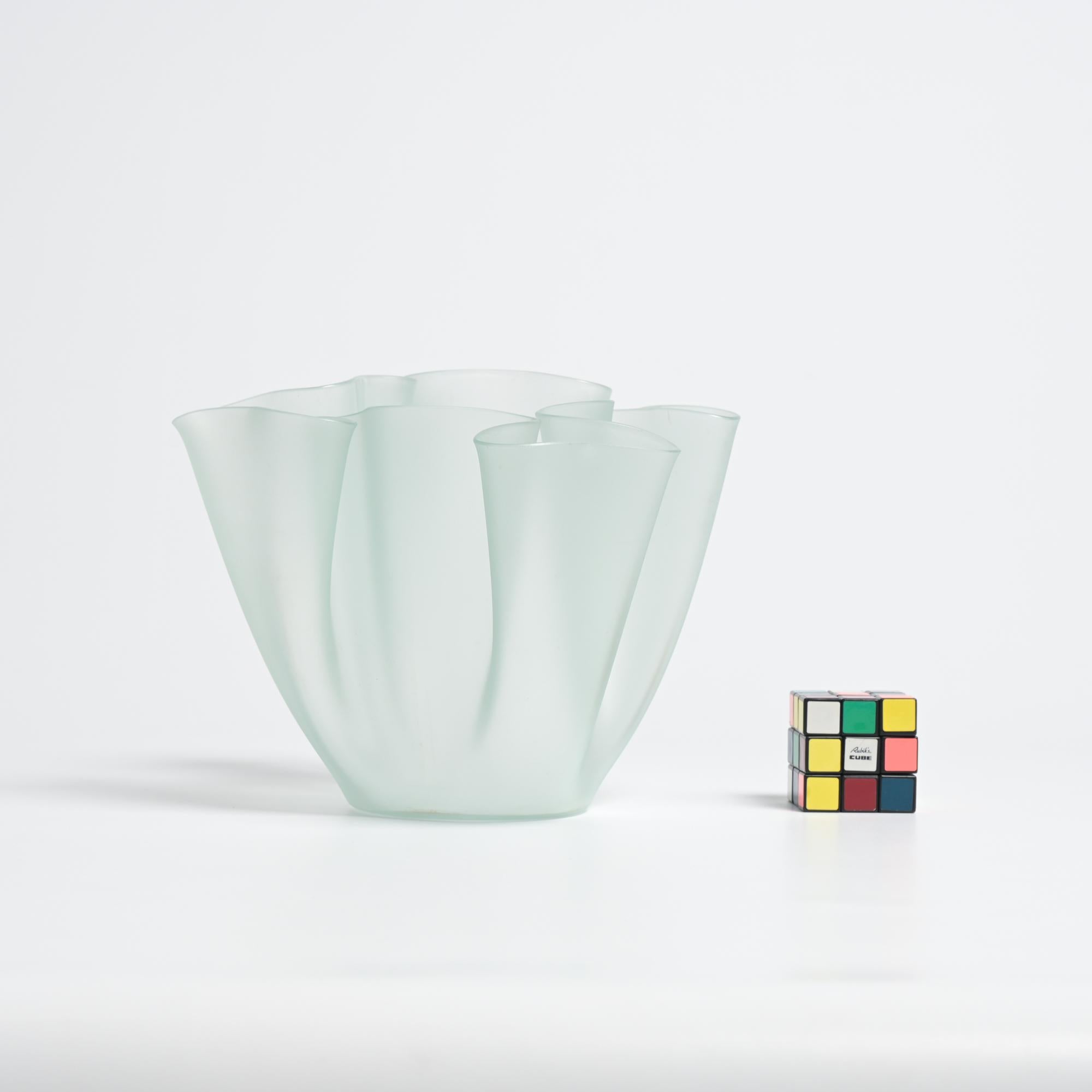 This extraordinary vase was designed by Pietro Chiesa in 1932 for Fontana Arte.

It is made from a hot folded sheet of glass. The manual production makes each vase unique. The vase has a light green tint with a matte finish.

This vintage Cartoccio