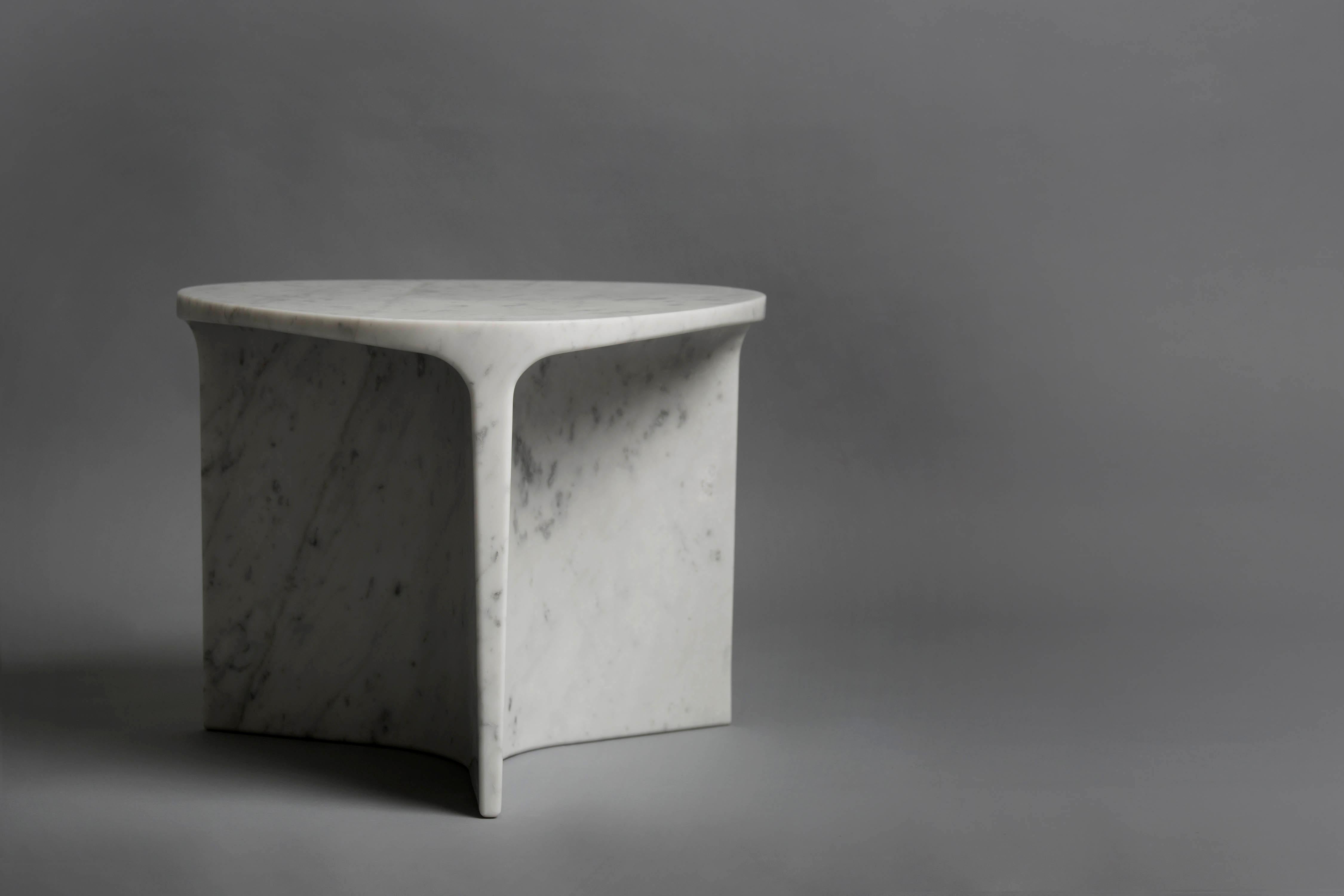 Carv occasional table is Cut from a single block of Italian Carrara marble.
Essential and organic design, naturally creating a flat tabletop flowing
to a Y - shaped foot, revealing the stone’s veins
from the exterior surface through to it’s