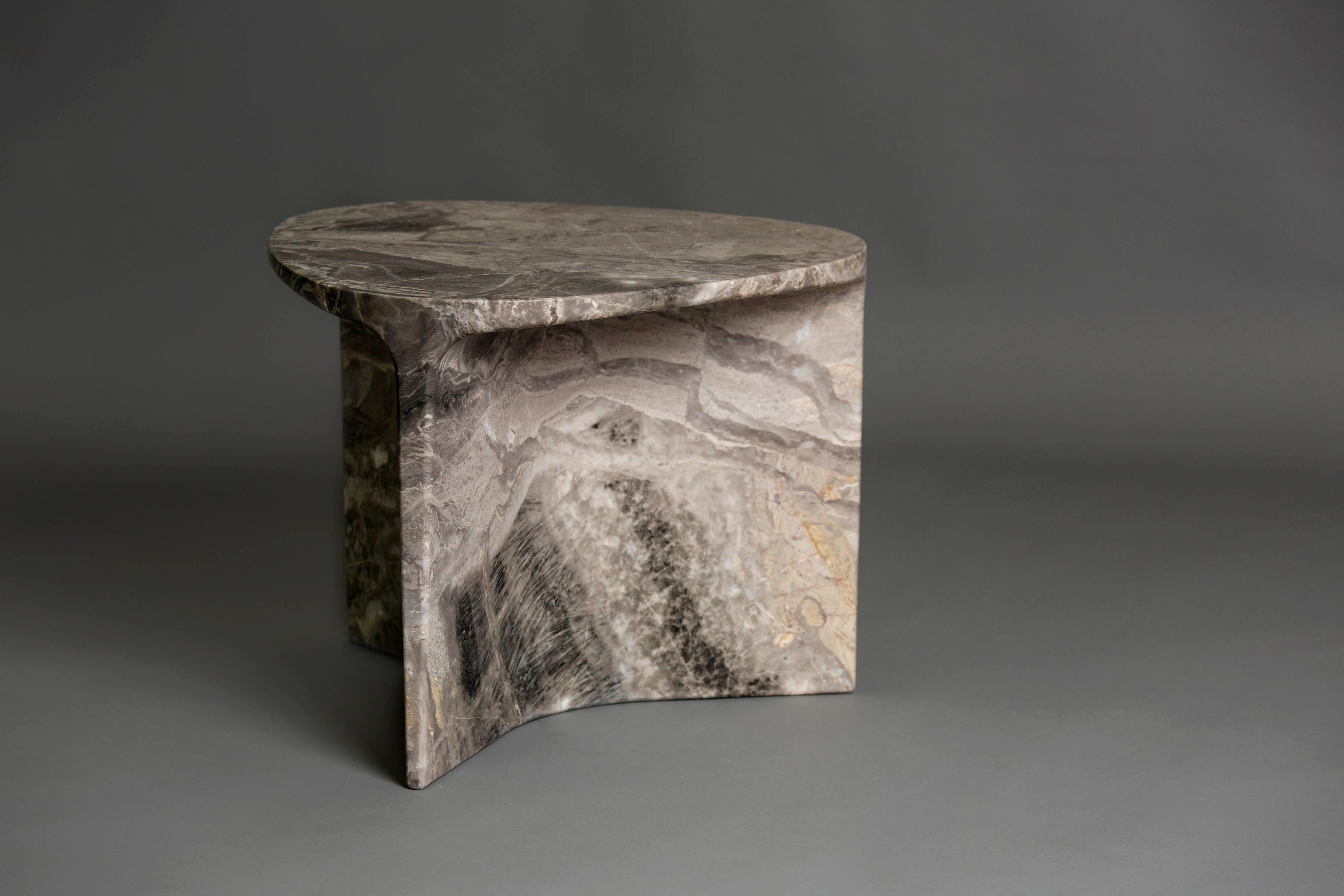 Carv occasional table is Cut from a single block of Italian Orobico marble.
Essential and organic design, naturally creating a flat tabletop flowing
to a Y - shaped foot, revealing the stone’s veins
from the exterior surface through to it’s