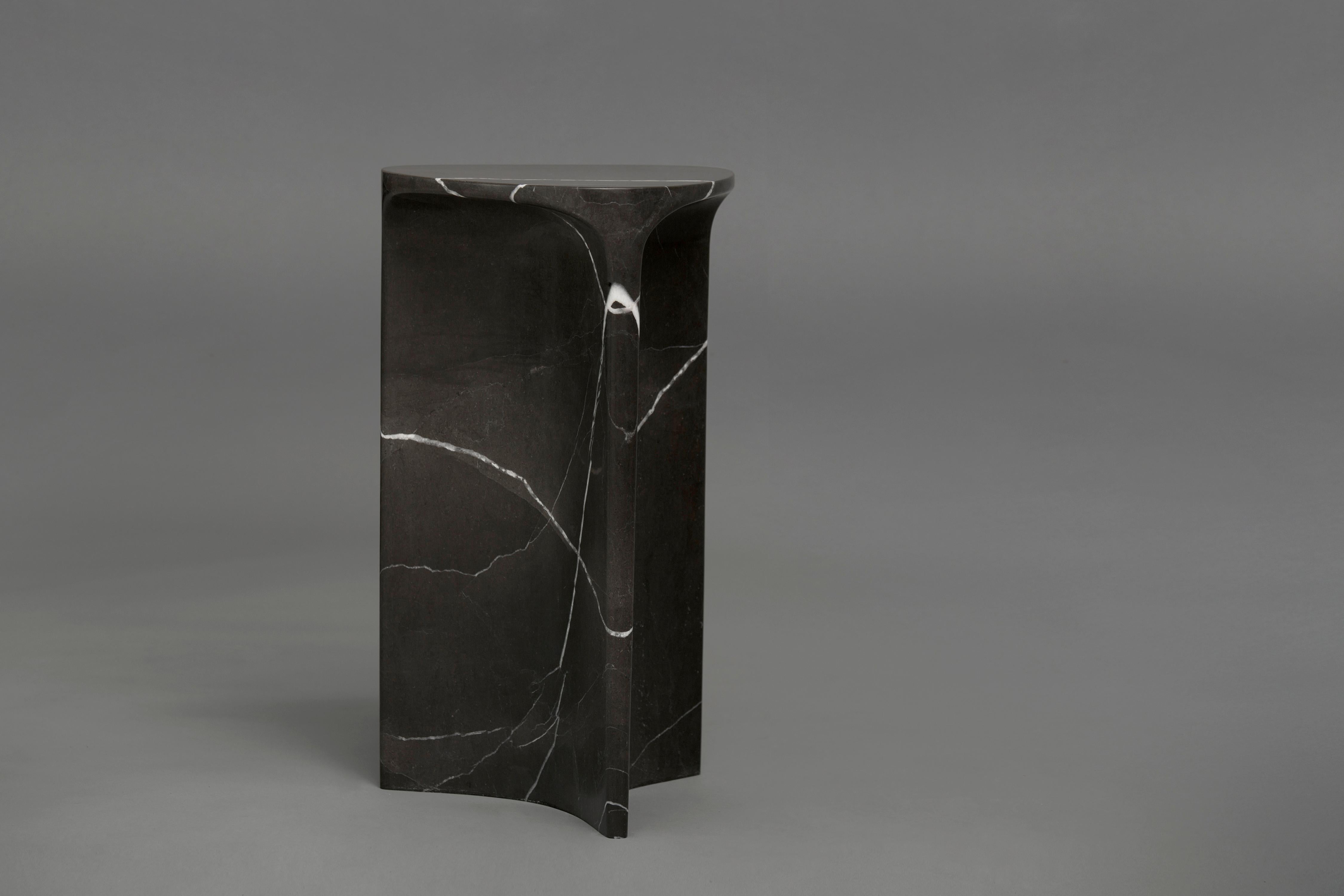 Carv occasional table is Cut from a single block of Nero Marquina marble.
Essential and organic design, naturally creating a flat tabletop flowing
to a Y - shaped foot, revealing the stone’s veins
from the exterior surface through to it’s