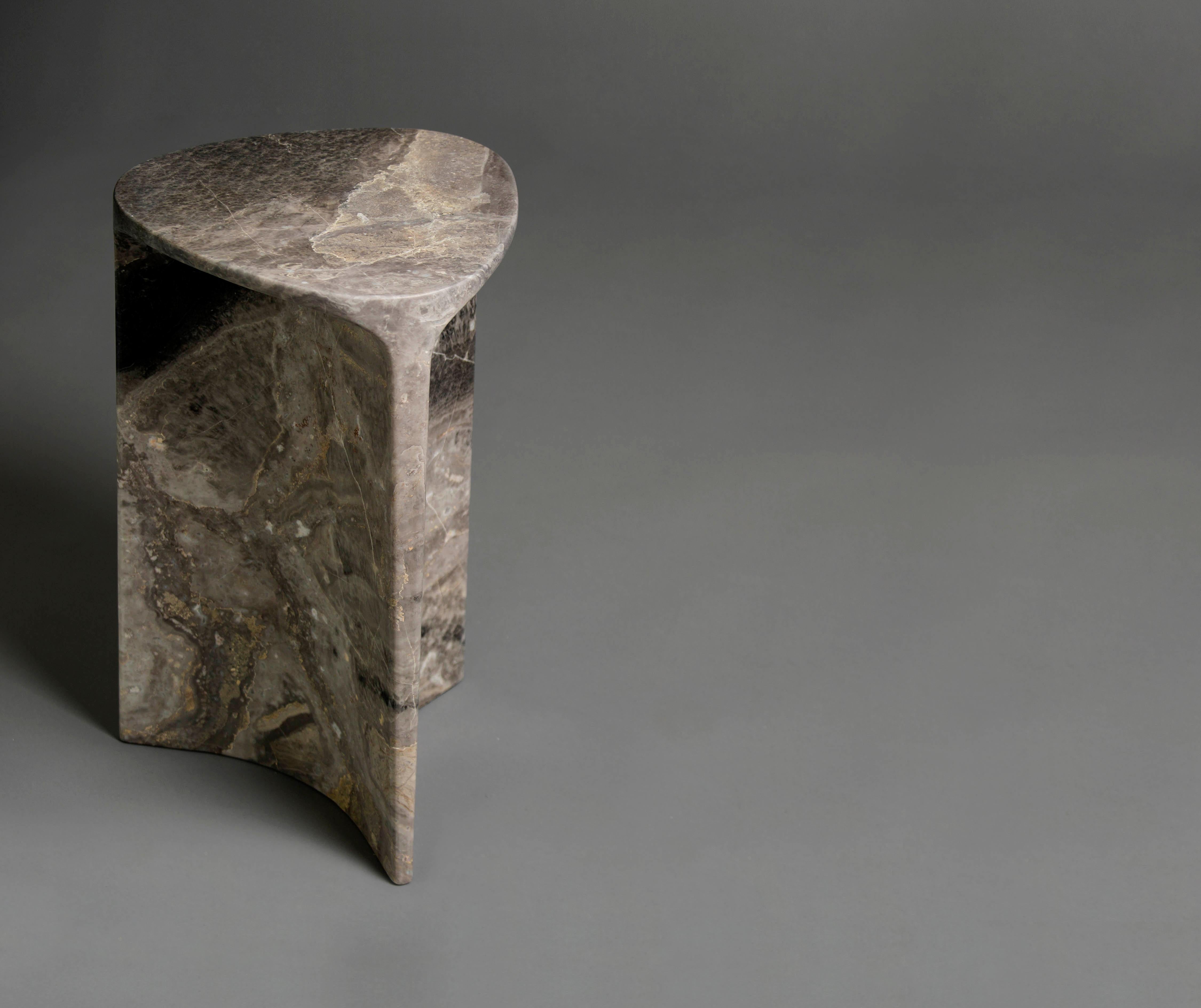 Carv occasional table is Cut from a single block of Italian Orobico marble.
Essential and organic design, naturally creating a flat tabletop flowing
to a Y - shaped foot, revealing the stone’s veins
from the exterior surface through to it’s