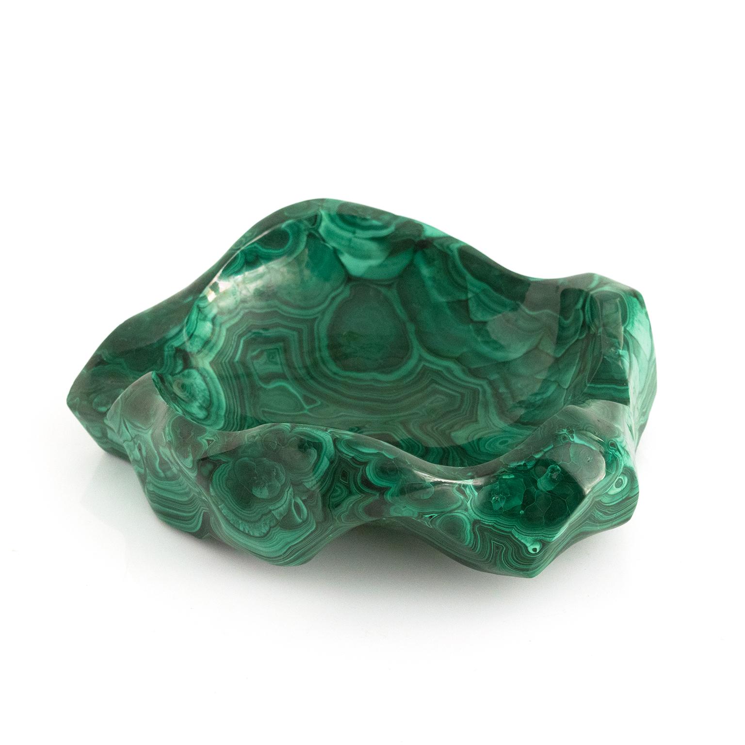 An organically carved stone bowl made from a single piece of polished malachite.

Measures: Width: 9” x 7” Height: 2.5”.