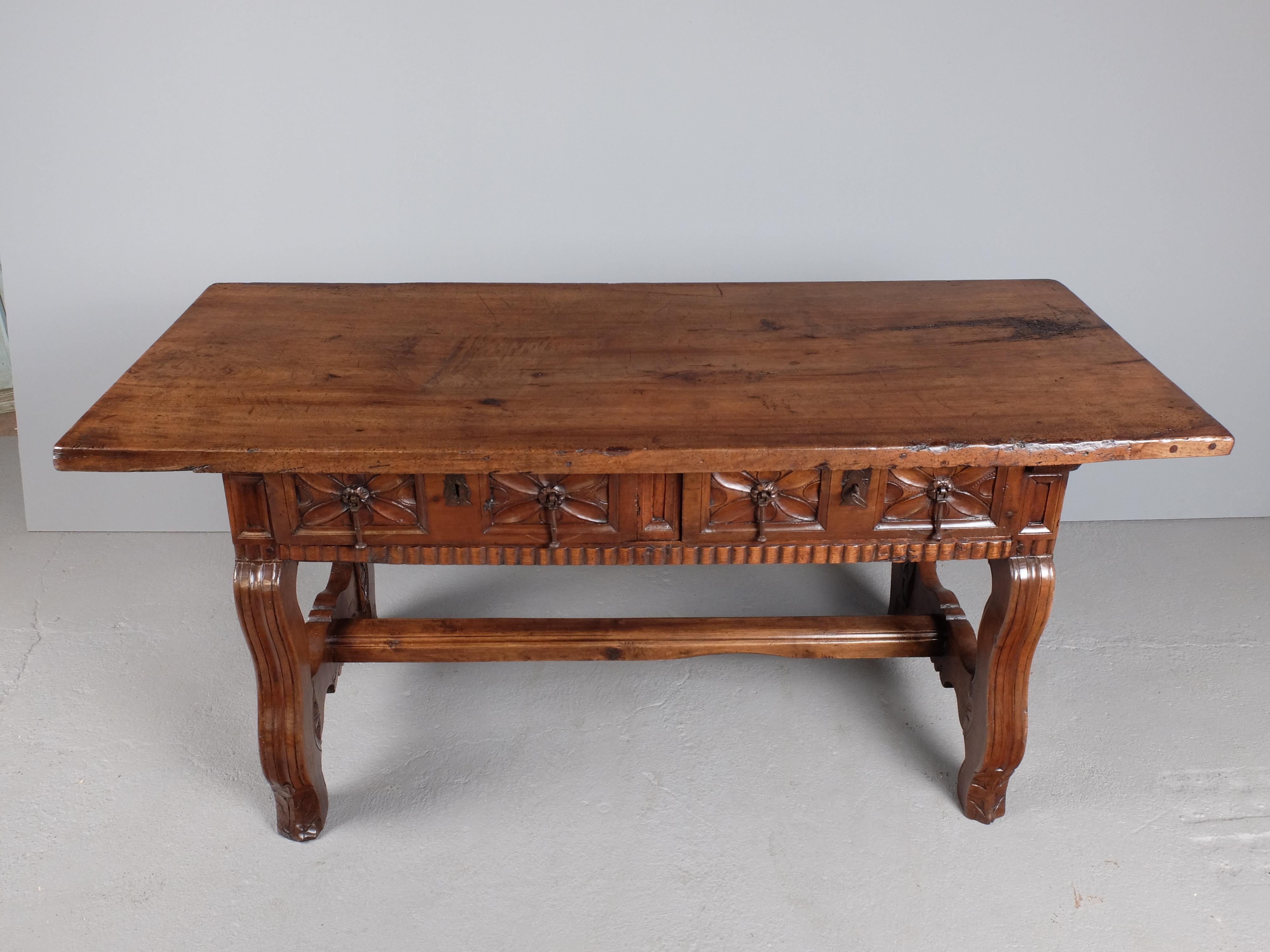 An important two-drawer Baroque library table from the provincial capital of Valladolid in Old Castile, Spain.

Constructed of solid light Spanish walnut with oak as the secondary wood on the insides of drawers, this mid to late 17th century table