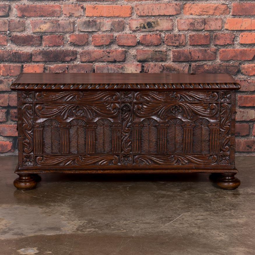 Traditionally, carved Swedish trunks were made of oak, so to have a trunk in carved pine, especially in this intermediate size, is a special find. Your eye is immediately drawn to the warm patina and elaborate carving of elongated swags, that seem