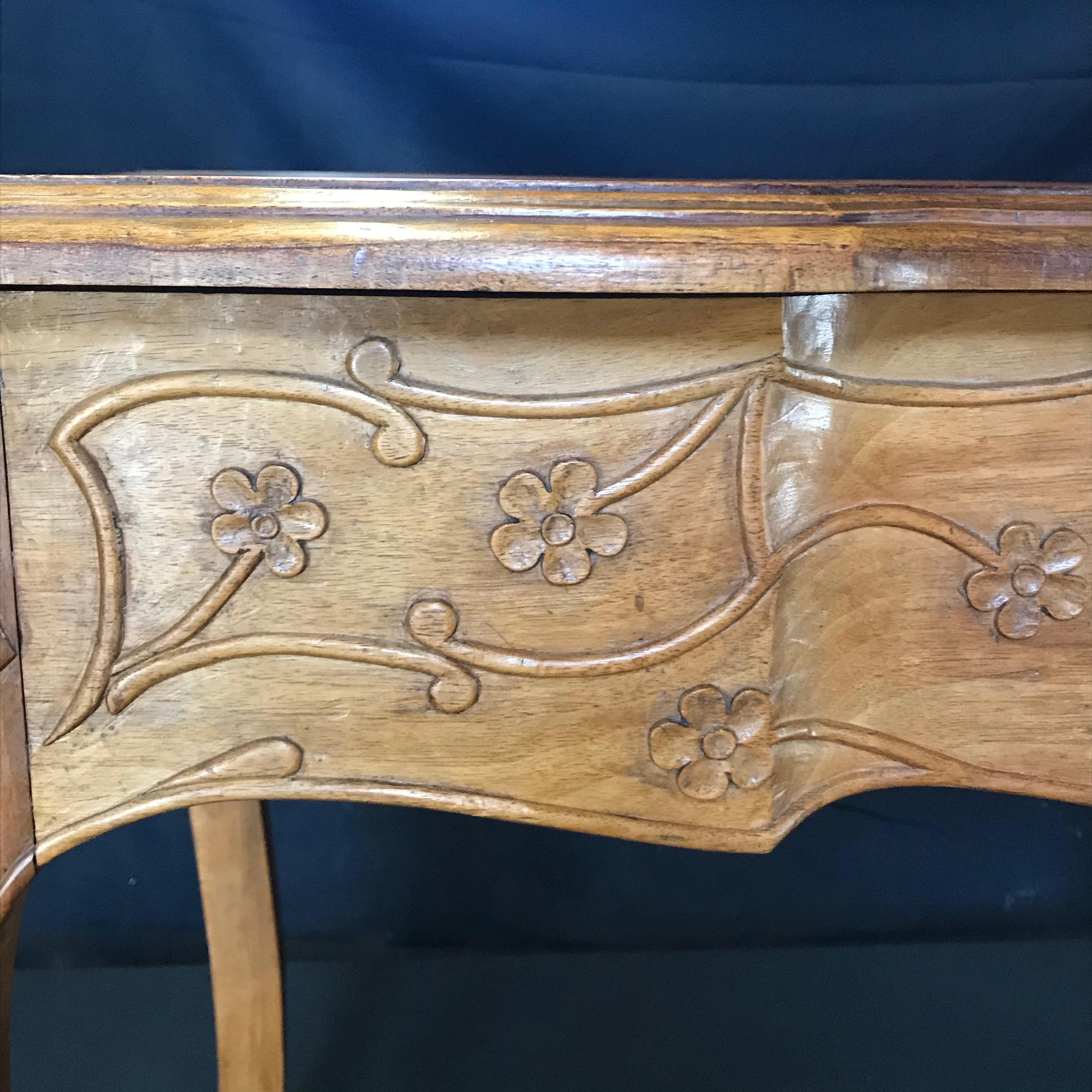 19th century country French Louis XV carved side table or desk. Can also be used as a game table. Hand carved floral and acanthus leaf artwork on the sides and cabriole legs. Gorgeous inset table top. 
Measures: Apron height 21.75
#3408.