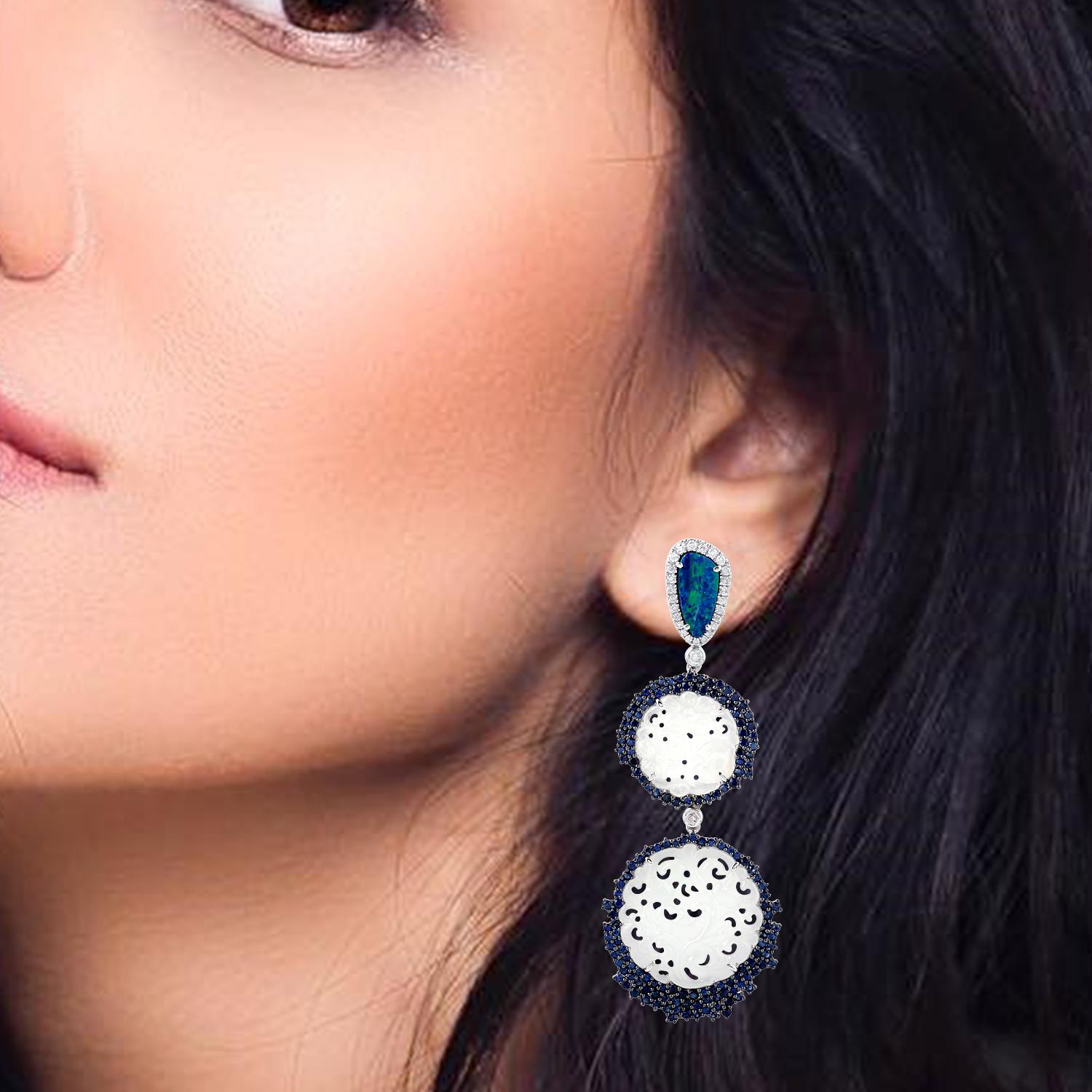 Cast from 18-karat gold, these stunning drop earrings are hand set with 23.59 carats Jade, 2.53 carats Opal, Sapphire and .65 carats of glimmering diamonds. 

FOLLOW  MEGHNA JEWELS storefront to view the latest collection & exclusive pieces.  Meghna