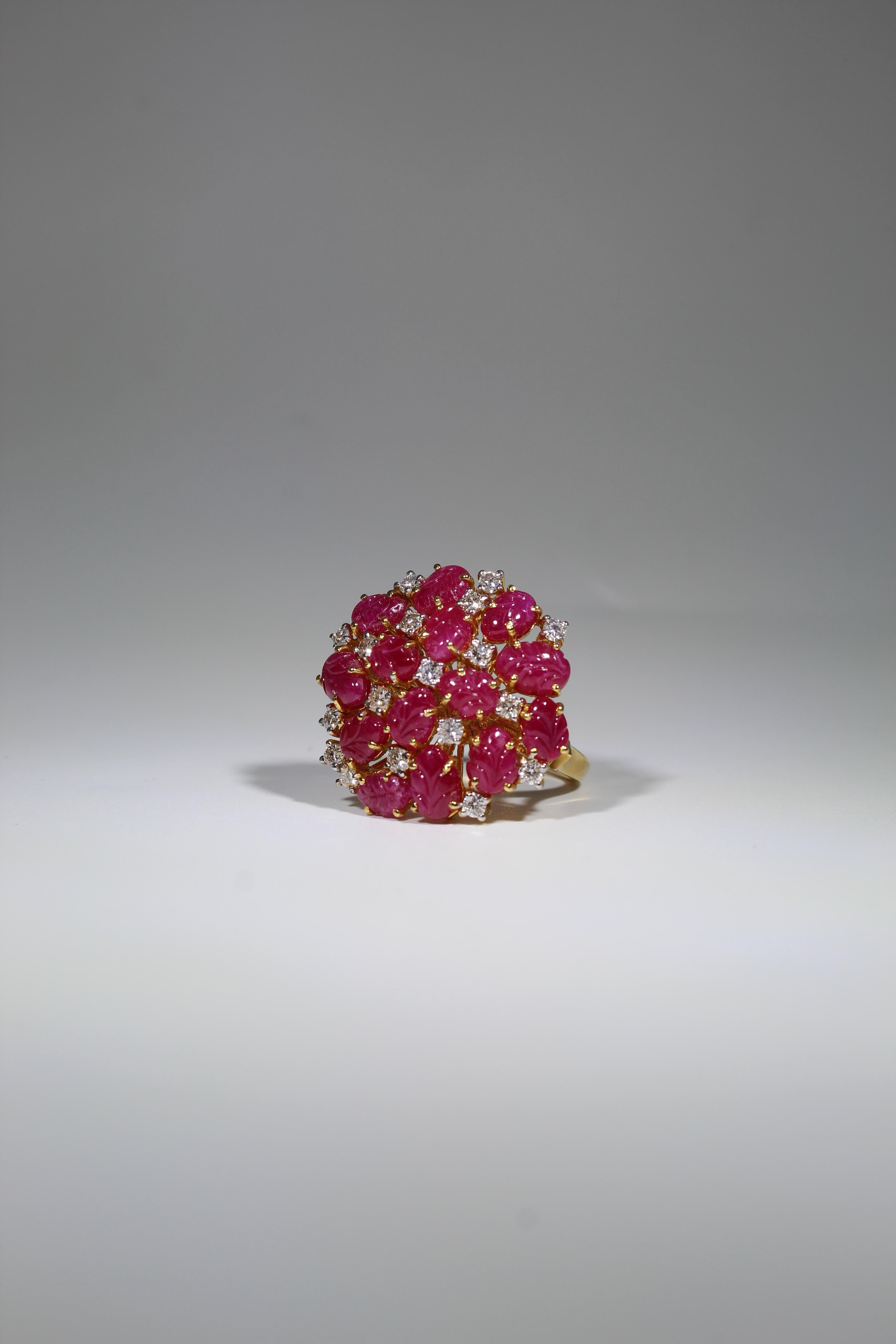 Introducing our Carved Ruby and Diamond Ring, a true masterpiece of craftsmanship and elegance that seamlessly combines the fiery allure of rubies with the brilliance of diamonds, set in luxurious 18K gold. This ring is a symbol of timeless beauty