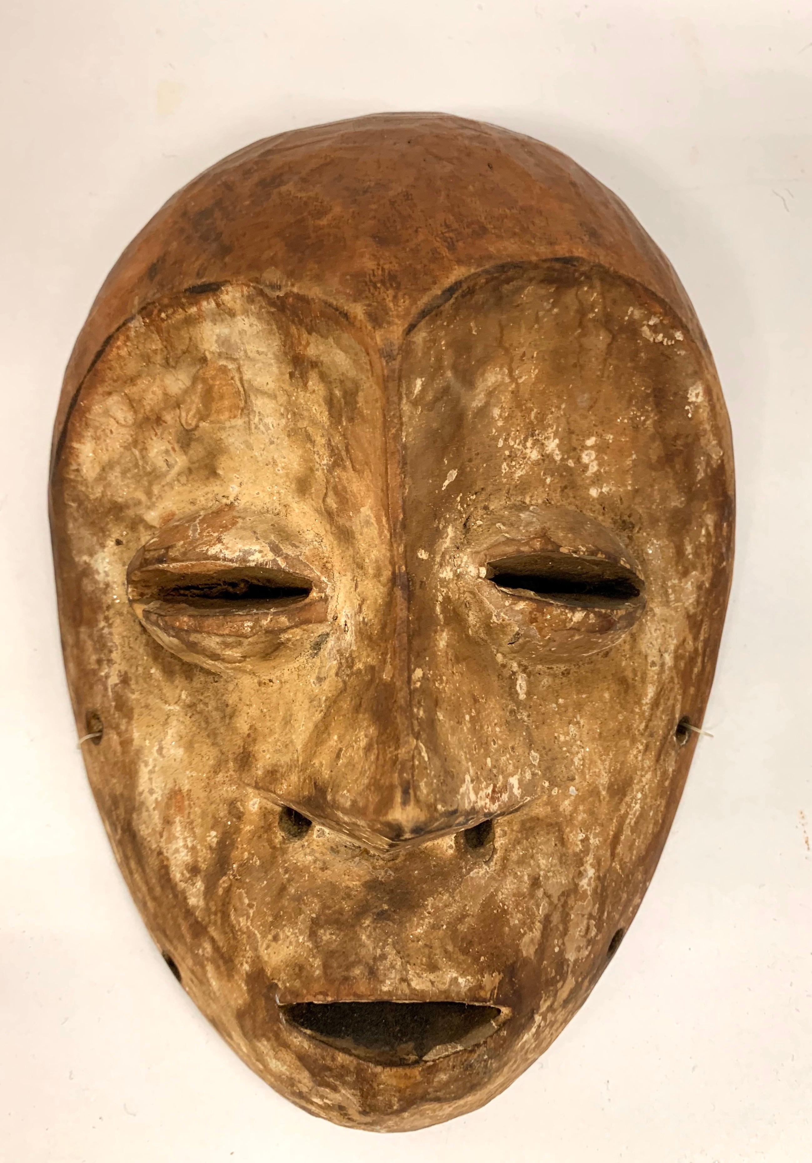 Magnificent African hand carved female mask from Punu Gabon. The white face represents the soul of an ancestor. The beautiful hairstyle is a common feature among the Punu women. In some cases scarification on foreheads are clearly visible.