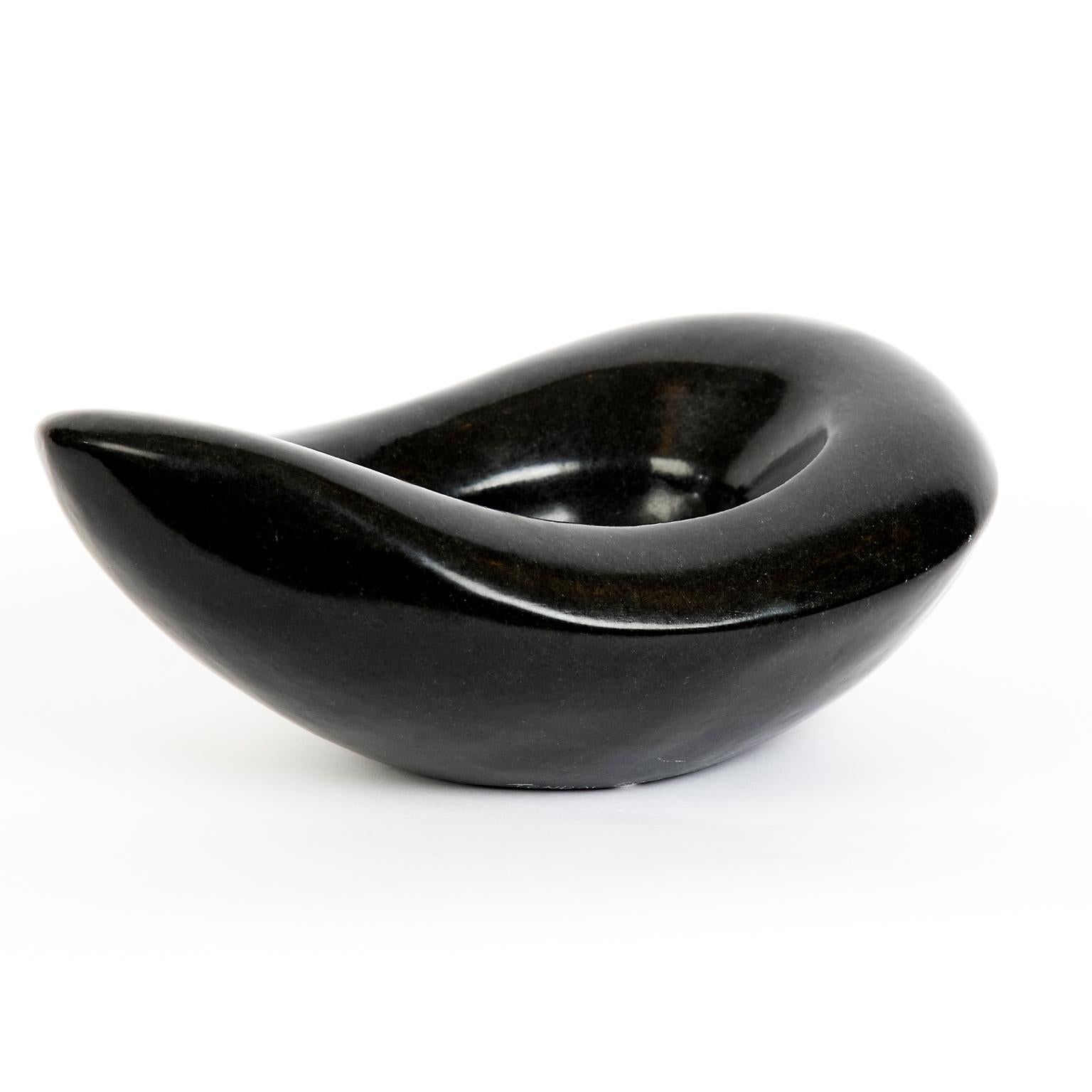 This sensuous hand carved and polished stone vessel from Zimbabwe is signed by the artist Tenuai Swaravaza and is reminiscent of the genius of 20th century French ceramicist Georges Jouves.
 